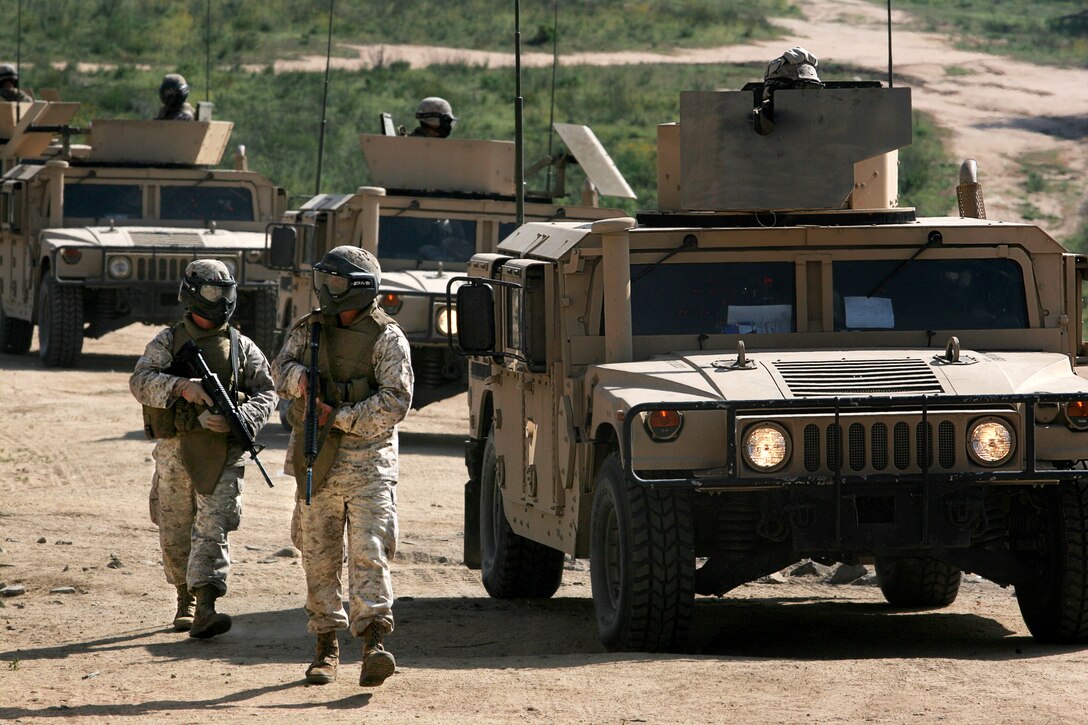 Marines with the 11th Marine Expeditionary Unit patrol into an urban training facility here during a personal security detachment training exercise March 20. The detachments from Marine Medium Helicopter Squadron 166, Combat Logistics Battalion 11 and the command element of the 11th MEU took part in a two-week course to prepare them for an upcoming deployment later this year.