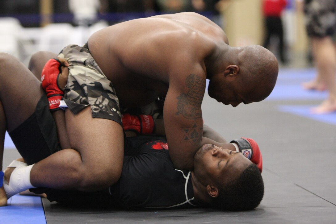 Fight Club 29 member Omar Askew chokes his opponent with his forearm during the Fight Expo pankration tournament at the Del Mar Fairgrounds in Del Mar, Calif., March 21.