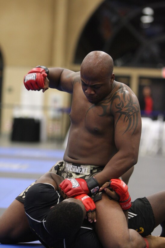 Fight Club 29 member Omar Askew mounts and pounds his opponent’s upper body during the Fight Expo pankration tournament at the Del Mar Fairgrounds in Del Mar, Calif., March 21.