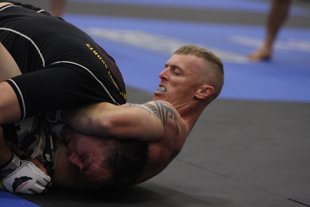 Light heavyweight Fight Club 29 member Allen McBroom applies a guillotine choke to his rival from the Marine Corps Base Camp Pendleton, Calif., team, during the Fight Expo pankration tournament at the Del Mar Fairgrounds in Del Mar, Calif., March 21.