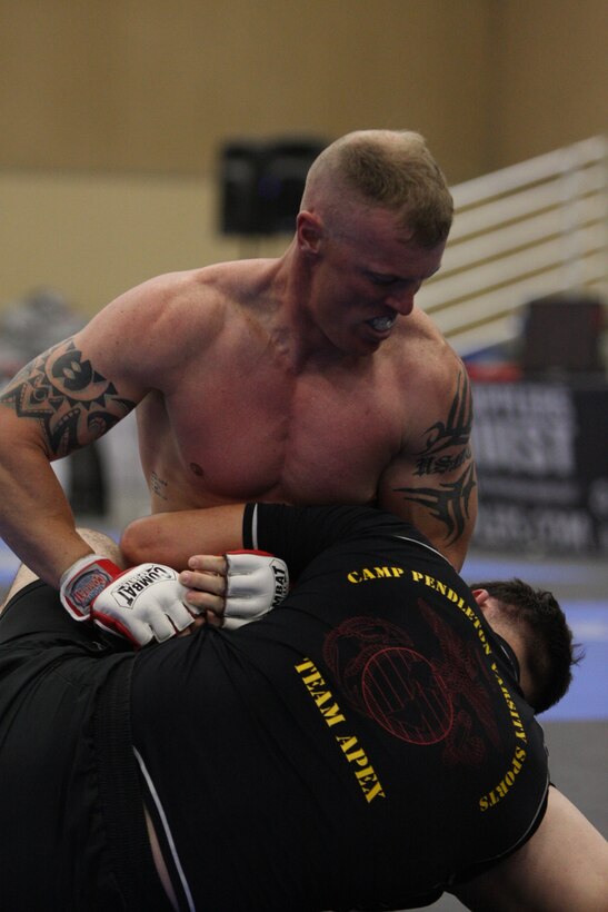 Light heavyweight Fight Club 29 member Allen McBroom brings his rival from the Marine Corps Base Camp Pendleton, Calif., team, down to the ground during the Fight Expo pankration tournament at the Del Mar Fairgrounds in Del Mar, Calif., March 21.