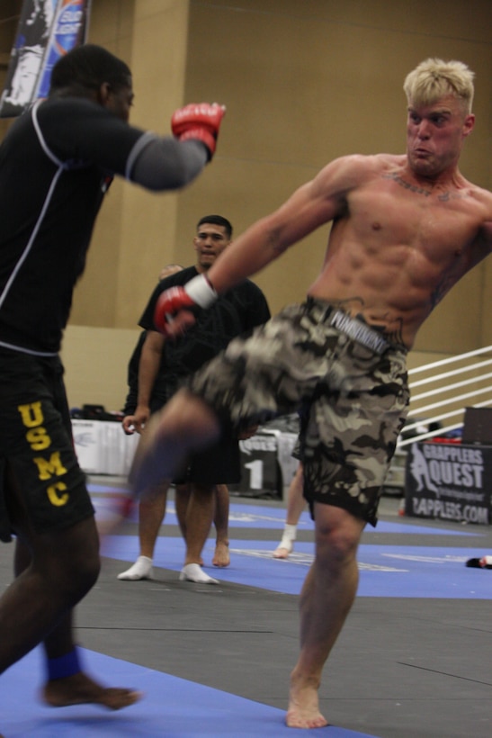 220-pound Fight Club 29 member Nate Wolf throws a powerful kick at his opponent from the Marine Corps Base Camp Pendleton, Calif., team, during the Fight Expo pankration tournament at the Del Mar Fairgrounds in Del Mar, Calif., March 21.