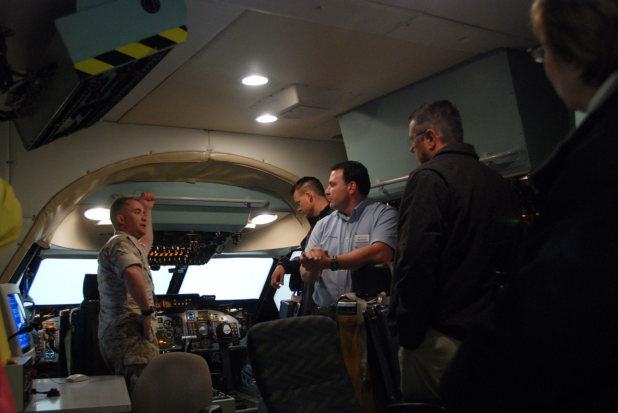 Civic leaders from Georgia, traveled to the 433rd Airlift Wing with the 94th Fighter Wing, Dobbins ARB. Mike Nason, a contractor with Flight Safety, answers thier questions about a flight deck simulator for the C-5A Galaxy aircraft. (U.S. Air Force photo/Airman Brian McGloin)