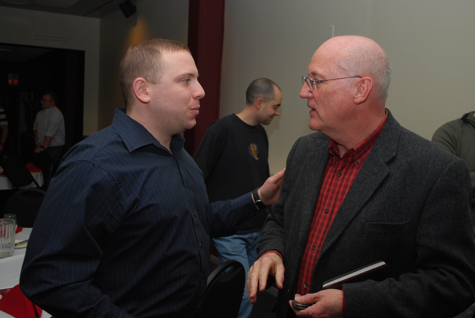 Capt. Mike Balzotti, 821st Support Squadron airport operations, speaks to Ch. (Maj. Gen.) Cecil Richardson, Air Force chief of chaplains, after the National Prayer Supper in the Top of the World Club ballroom March 19. Chaplain Richardson, the guest speaker, spoke on the story of David and Goliath found in Jewish Scripture, the Christian Bible and the Muslim Koran. The chapel-sponsored supper was originally meant to be a luncheon, but a strong winter storm at Thule delayed Chaplain Richardson's flight in Kangerlussuaq, Greenland (formerly Sondrestrom Air Base), for more than seven hours.