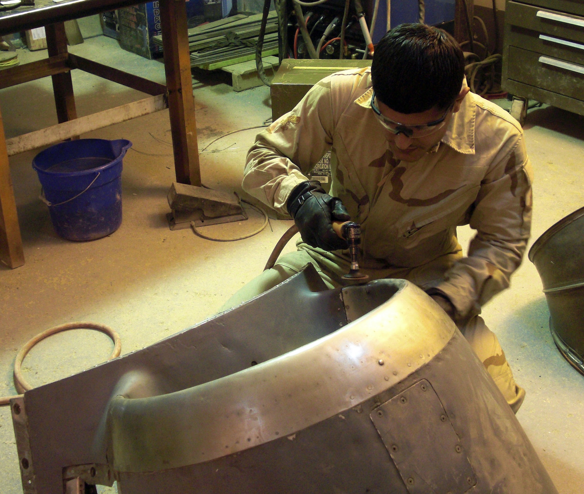 Iraqi machinist, Ehab, from New Al Muthana Air Base, blends a C-130 chin scoop repair after welding a crack. The chin scoop was a $60,000 item repaired and returned to the Iraqi supply system for re-issue. (Courtesy photo)