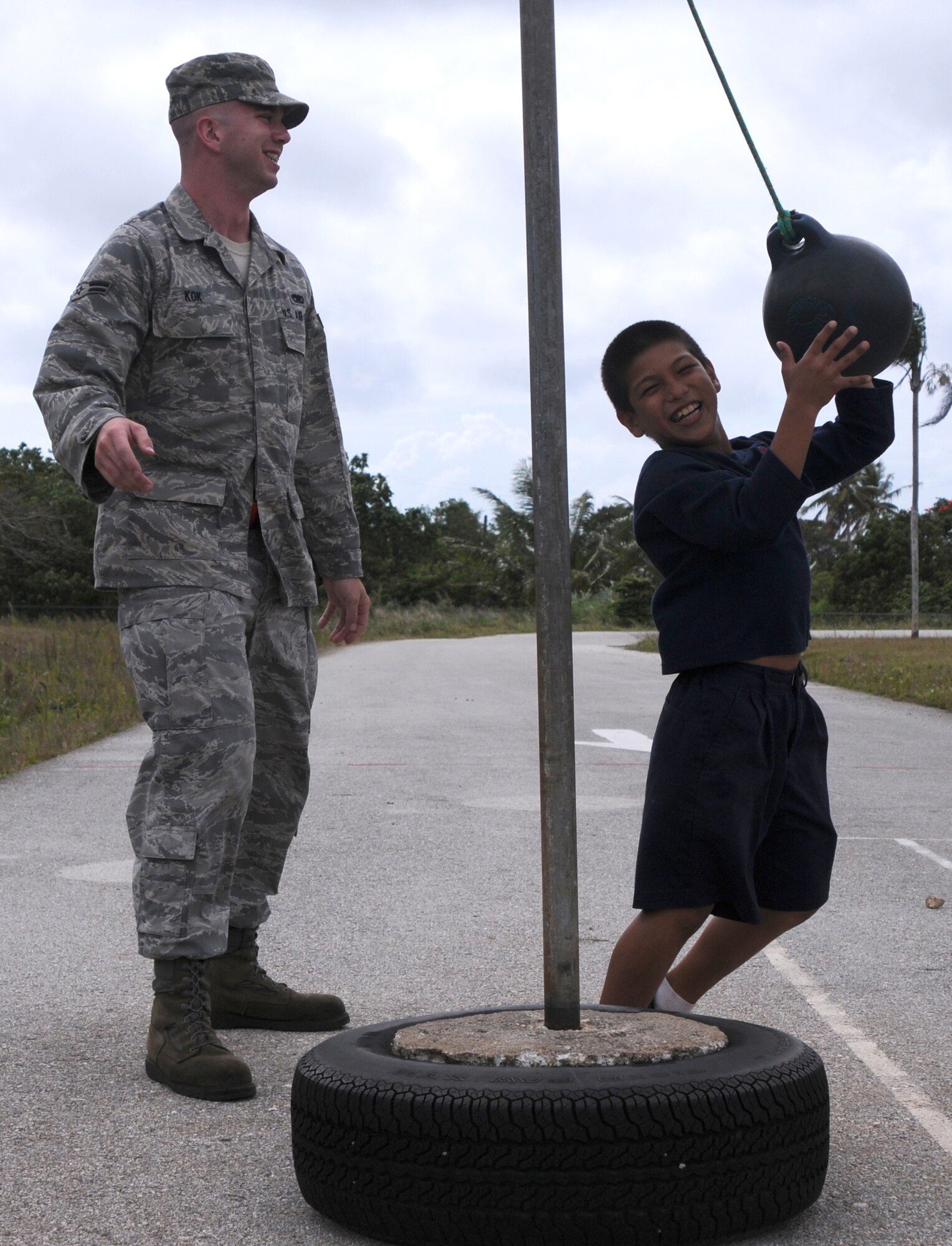 Airman 1st Class Daniel Kok,  36th Expeditionary Aircraft Maintenance Squadron weapon loader, plays tetherball with a child at Machananao Elementary School during a tutoring break March 19, 2009. Airmen from the 36th Expeditionary Aircraft Maintenance Unit, deployed here from Elmendorf Air Force Base, Alaska, have been spending their time bettering the local community of Guam through various volunteer efforts.
(U.S. Air Force photo by Senior Airman Ryan Whitney)