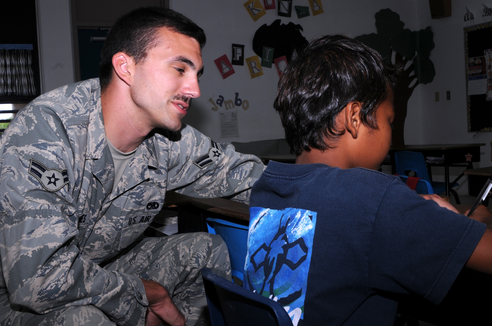 Airman 1st Class Erik Johannas,  36th Expeditionary Aircraft Maintenance Squadron weapon loader, helps a third grader at  Machananao Elementary School during a tutoring session March 19, 2009. Airmen from the 36th Expeditionary Aircraft Maintenance Unit, deployed here from Elmendorf Air Force Base, Alaska, have been spending their time bettering the local community of Guam through various volunteer efforts.
(U.S. Air Force photo by Senior Airman Ryan Whitney)
