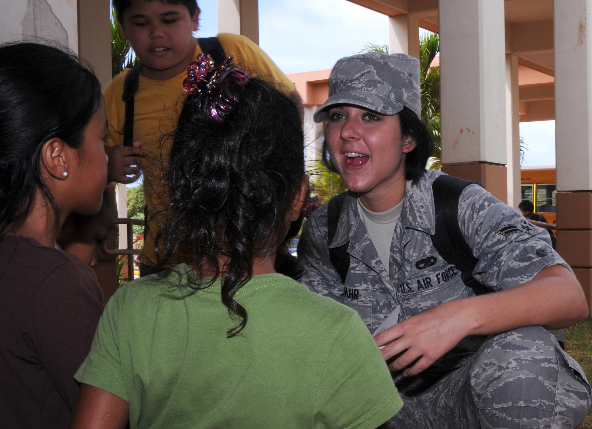 Airman 1st Class Shanell Gutjahr,  36th Expeditionary Aircraft Maintenance Squadron weapon loader, greets children at Machananao Elementary School March 13, 2009.Airmen from the 36th Expeditionary Aircraft Maintenance Unit, deployed here from Elmendorf Air Force Base, Alaska, have been spending their time bettering the local community of Guam through various volunteer efforts.
(U.S. Air Force photo by Senior Airman Ryan Whitney)
