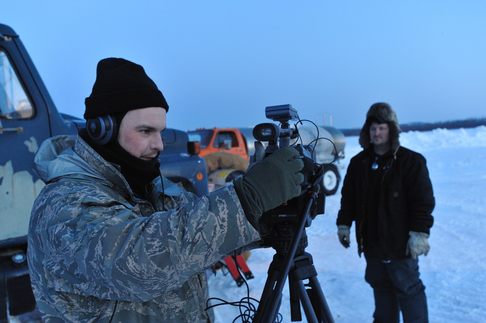 GALENA, Alaska-- Staff Sgt. Mark Leahy, 3rd Wing, sets up his video equipment for an interview with Dave Vandergriff a Marsh Creek LLC employee on the Yukon River, March 17. Marsh Creek LLC, a contractor for the 611th Civil Engineer Squadron, is building an ice bridge to move supplies for demolition of the former Kalakaket Creek Radio Relay Station that is located 310 miles northwest of Anchorage. The station was built in 1957 and was used to transfer defense communications between White Alice Communication Systems up for demolition because of satellite technology in mid 1970s. (U.S. Air Force photo by Senior Airman Jonathan Steffen)