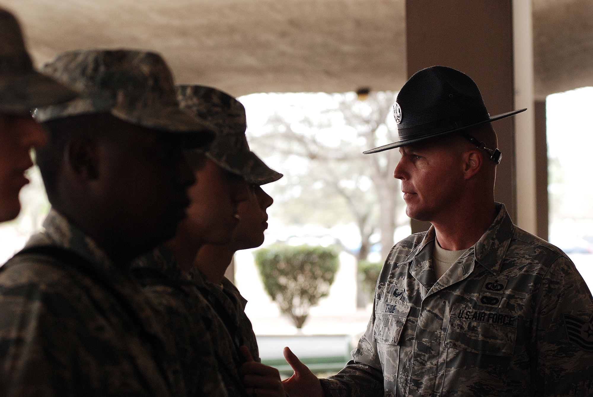 Technical sergeant Terrance Thoe, a Reservist from the 433rd Airlift Wing serves as a Military Training Instructor side by side with active-duty MTI's. Sergeant Thoe takes a moment to share words of encouragement to a flight of basic trainees on the pad of the 433rd Training Squadron. (U.S. Air Force photo/Airman Brian McGloin)