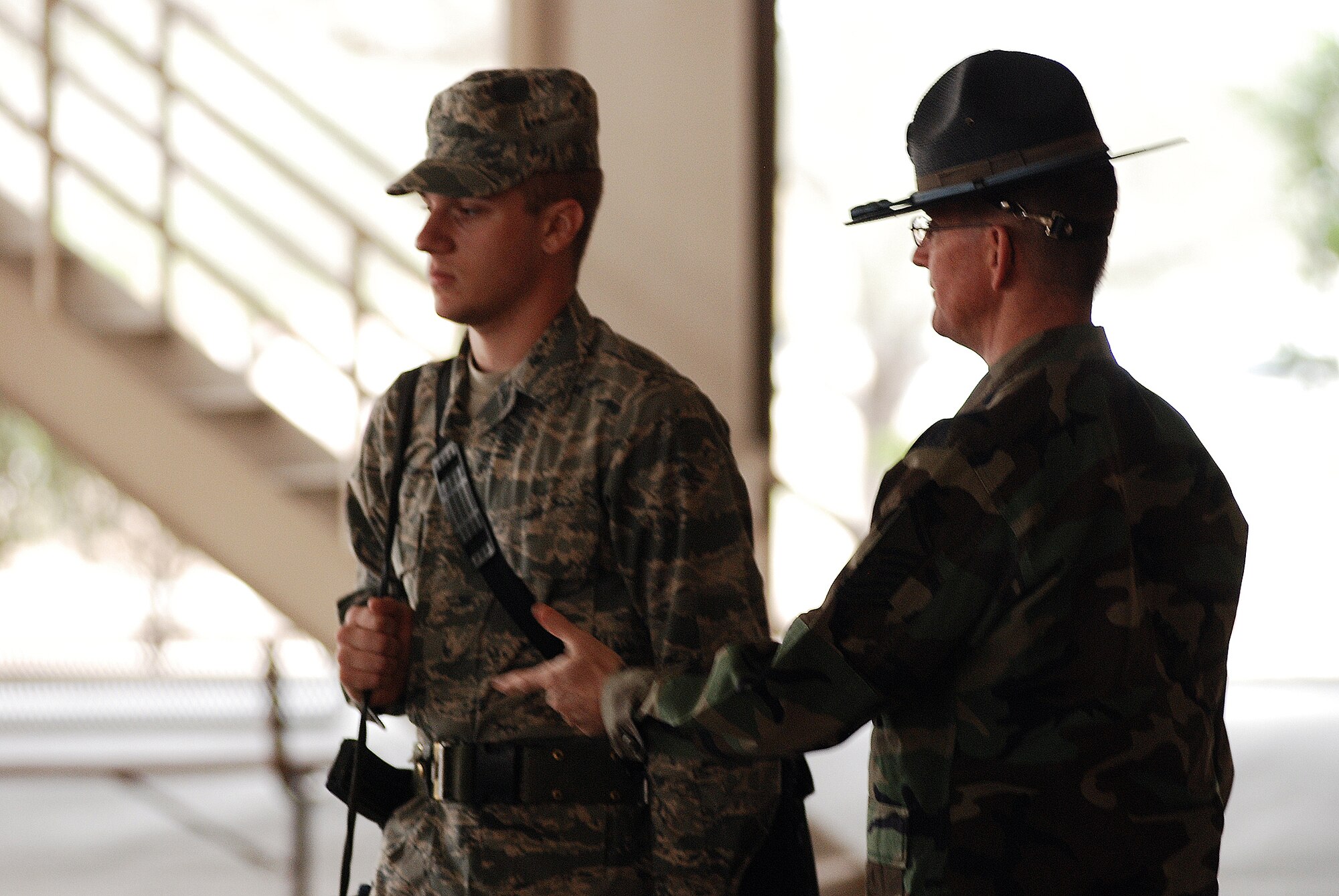 Master Sgt. Kenneth Allen, a Reservist and Military Training Insctructor from the 433rd Airlift Wing, explains to a basic trainee proper techniques of formation. Reservists such as Sergeant Allen work side by side with their fellow active-duty MTI's providing training to tommorow's Airmen. (U.S. Air Force photo/Airman Brian McGloin)