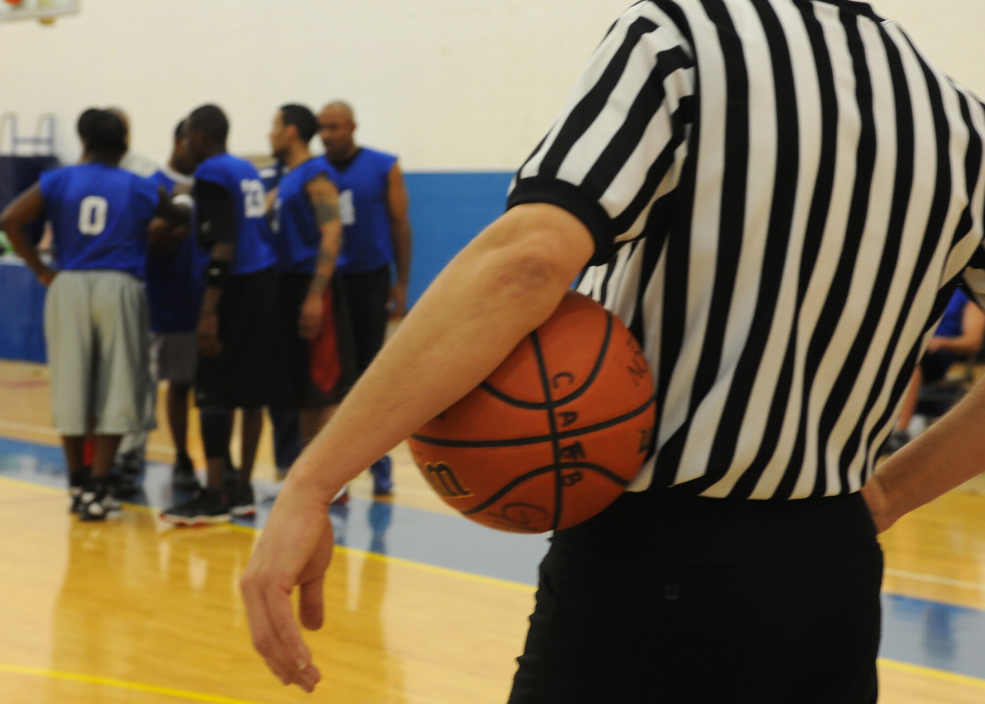 CANNON AIR FORCE BASE, N.M. - A referee holds the ball during a time-out at the base intramural basketball championship game. The 27 Special Operations Civil Engineer Squadron defeated the 27 Special Operations Force Support Squadron 50-42 March 18. (U.S. Air Force photo/ Airman 1st Class Evelyn Chavez) 