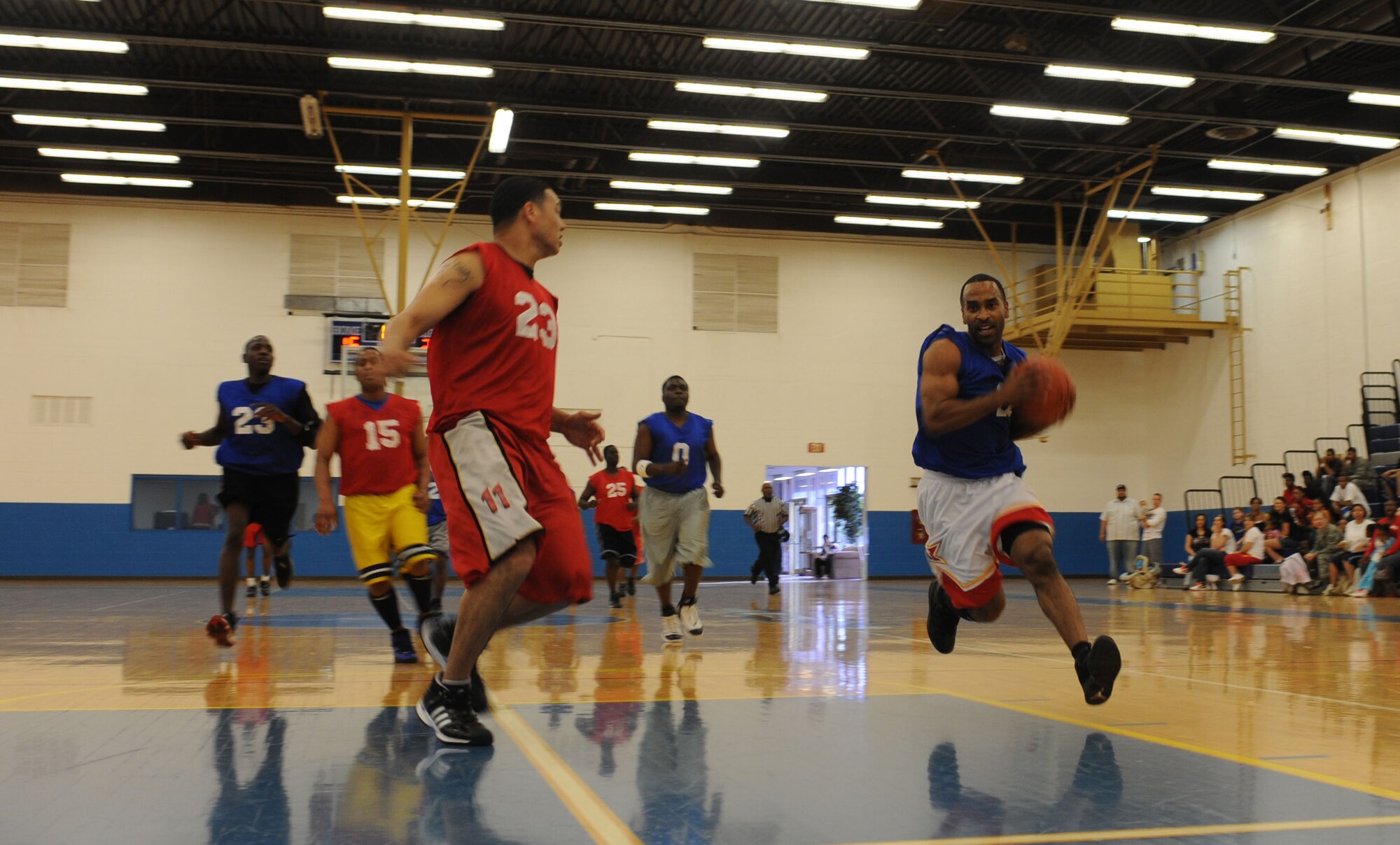 CANNON AIR FORCE BASE, N.M. - Special Agent Tarick Harding, Air Force Office of Special Investigations, drives to the basket for a layup during the base intramural basketball championship. The basketball matchup was between the 27th Special Operations Civil Engineer Squadron and 27th Special Operations Force Support Squadron March 18. 27 SOCES defeated 27 SOFSS 50-42 March 18. (U.S. Air Force photo/Airman 1st Class Evelyn Chavez)