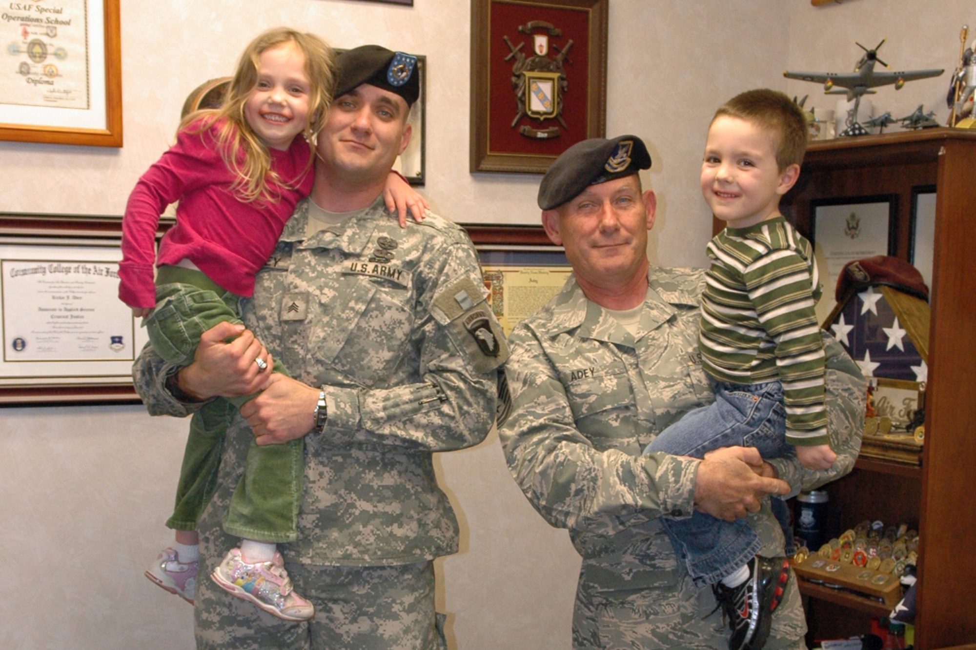 Master Sgt. Rickie J. Adey Sr., senior air reserve technician, 917th Security Forces Squadron at Barksdale Air Force Base, La., and US Army Sergeant John Adey, a combat medic with the 101st Airborne at Fort Campbell, Ky, hold John’s children, Libby, 4 and Adam, 3 during a family visit at Barksdale. 

John, who is Master Sgt. Adey’s oldest twin son recently returned from his second tour overseas at Kabul, Afghanistan, where he cared for US and coalition forces. His first tour was in Ramadi, Iraq.  

John is now actively pursuing his degree through the University of Kentucky in hopes of becoming an Army officer. MSgt Adey’s daughter Tanya, is going for her nursing degree through University of South Dakota. The youngest son, Rickie Jr. is a detective with Prince Georges County Police Department, Maryland.   

Master Sgt. Adey is also pursuing a Bachelors of Science degree in Social and Criminal Justice through Ashford University.      

“Education is essential now for any military member to advance so I am additionally proud that John has started his school,” said MSgt Adey. “My sons and daughter are heroes. Everyone has a hero…I have three. They have done more than I ever have.” 
