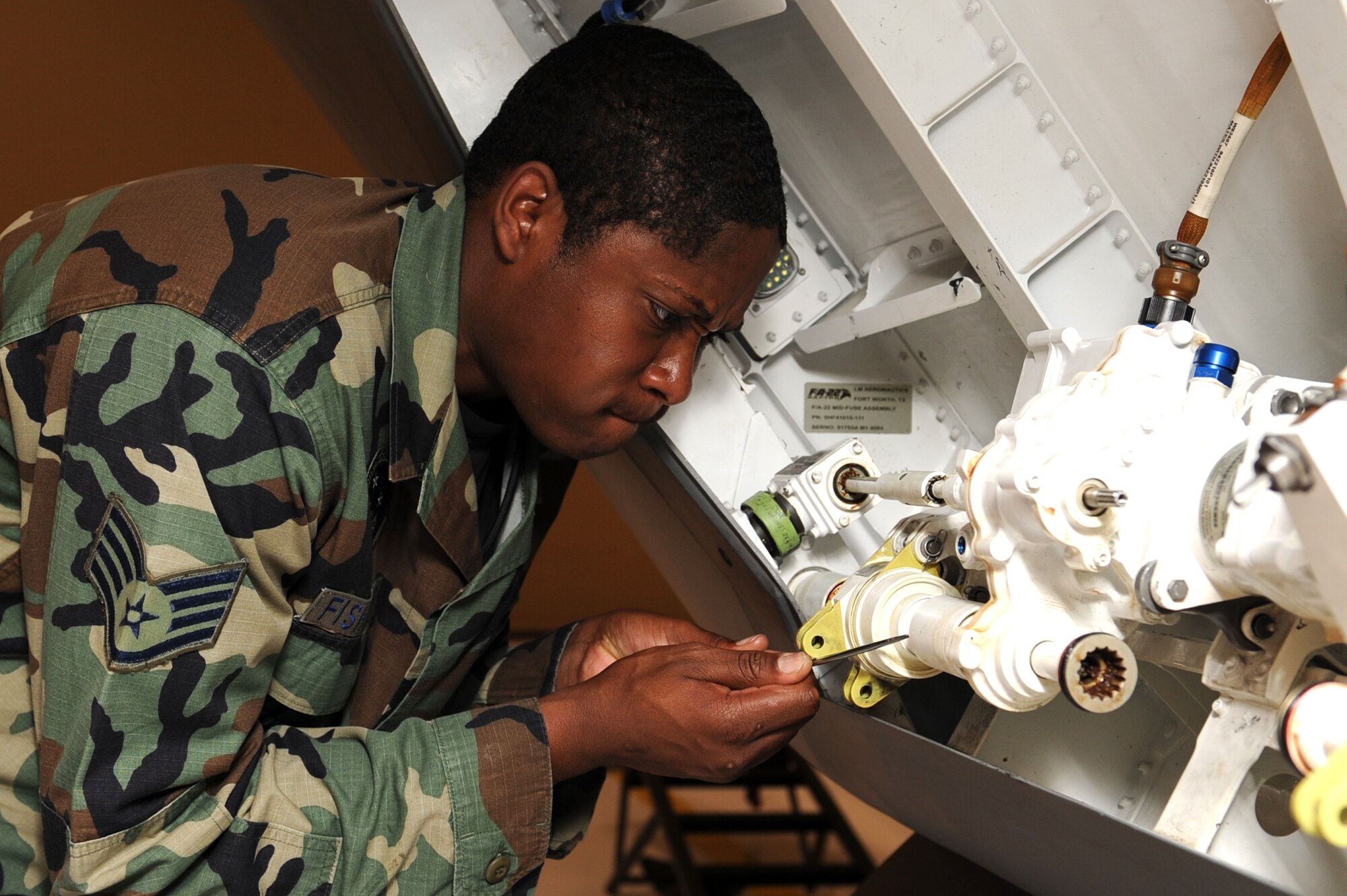 Staff Sgt. Ernest Fishburne, 49th Aircraft Maintenance Squadron, performs maintenance on the F-22A Raptor, March 19, at Holloman Air Force Base, N.M. The 49th Maintenance Group maintains aircraft, propulsion, avionics and accessory systems for the F-22A Raptor. (U.S. Air Force photo/Airman 1st Class Rachel Kocin)