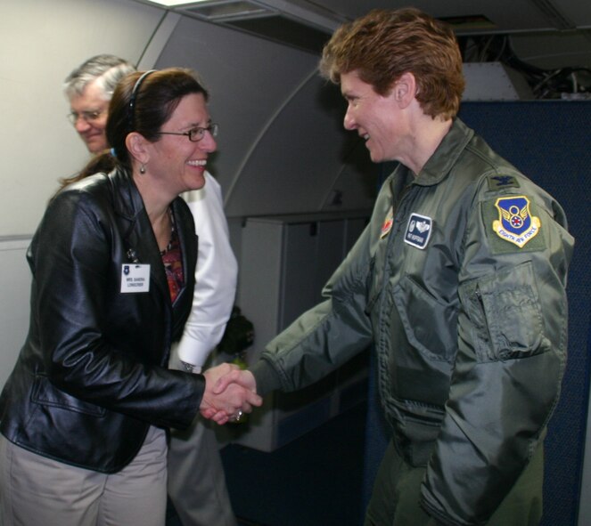 Col. Patricia Hoffman, commander, 552nd Air Control Wing, receives thanks from Ms. Sandra Longcrier, chair, Cleveland County Business & Industry Council, vice president, OG&E, after a tour of the E-3 March 19.