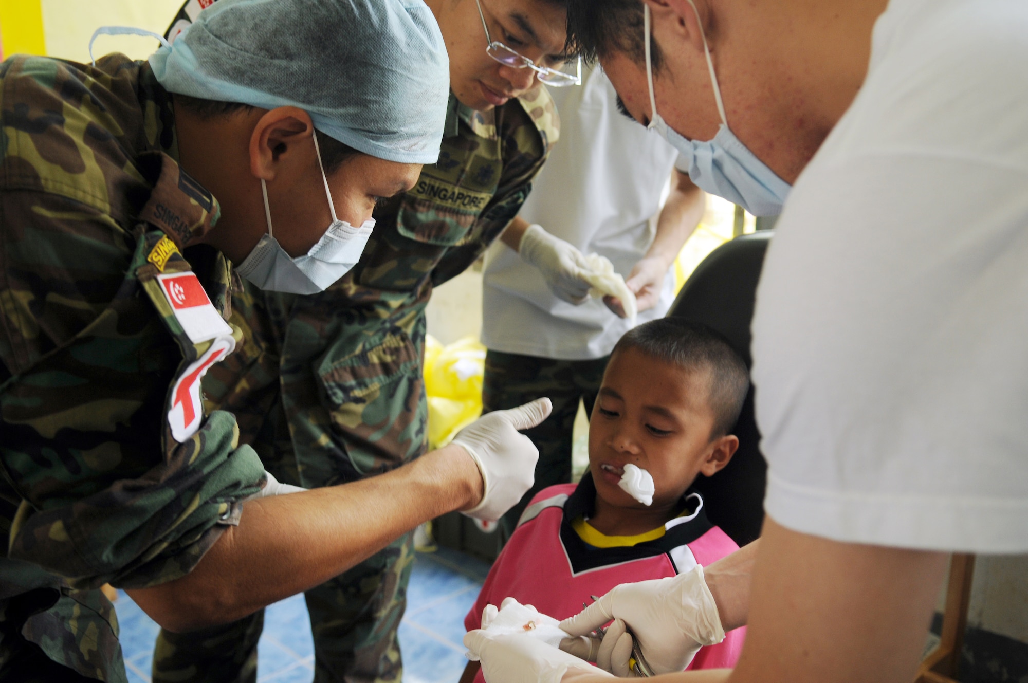 A team of Singaporean Dentists give a thumbs-up after performing a tooth extraction during a joint and multinational humanitarian mission to provide much needed dental care to Thailand's underprivileged during Cope Tiger 2009 on March 16. Cope Tiger is an annual exercise held in Thailand to improve combat readiness and combined and joint interoperability of U.S., Thai and Singaporean forces while enhancing regional security and providing humanitarian support. (U.S. Air Force photo/Staff Sgt. Angelique Perez)