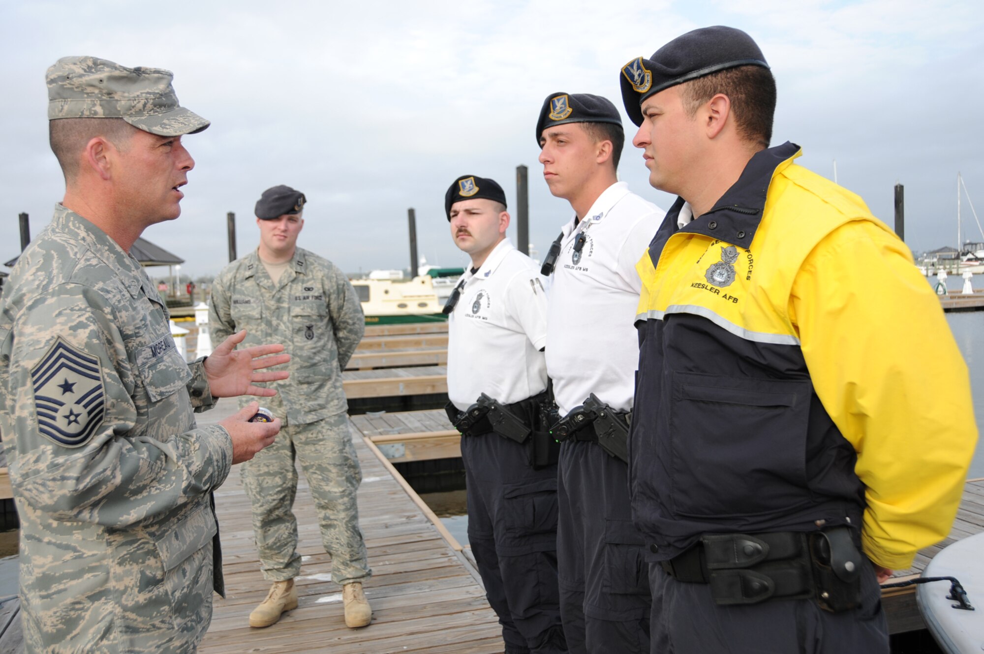 From left, Chief Master Sgt. Paul Moreau, 2nd Air Force command chief, accompanied by Captain Williams, presents 2nd Air Force coins to Sergeant Pike and Airmen Hemphill and Vogel for their actions in rescuing the student kayakers.  (U.S. Air Force photo by Kemberly Groue)