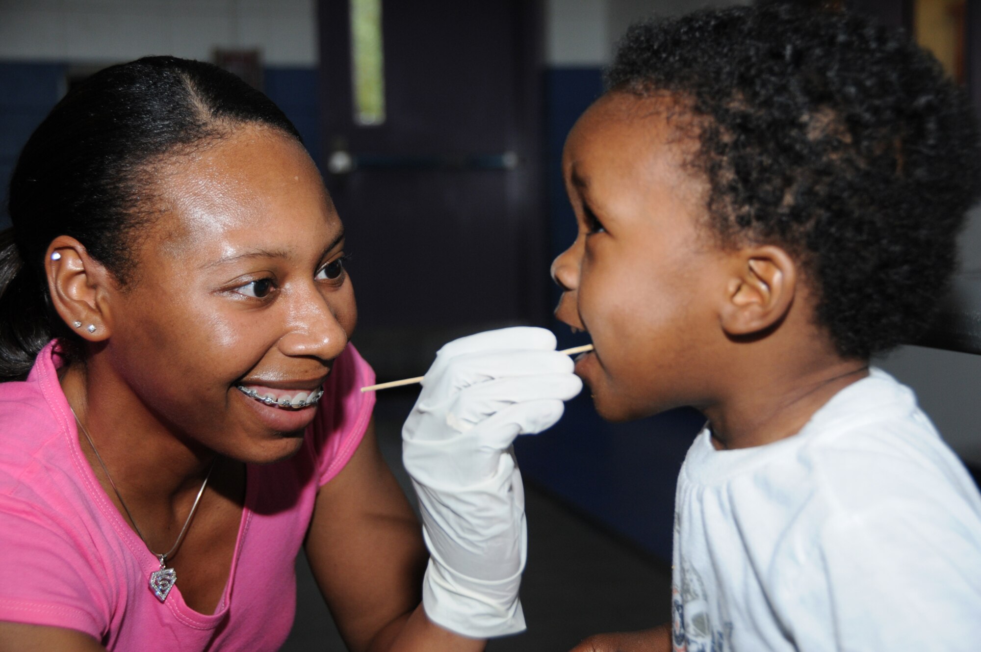 Staff Sgt. Stephanie Brown, 81st Medical Support Squadron, swabs the inside of 1-year-old Justin Hardiman’s cheek for a DNA sample during the Mississippi Child Identification Program’s visit to Keesler Saturday.  Justin’s mom is Staff Sgt. Jacqueline Scott, 81st Medical Operations Squadron.  Parents received a disk which is registered with the National Amber Alert System with fingerprints, bite impression, DNA sample, video recording and other information which can help law enforcement agencies search for a missing child.  Capt. Gary Thiel, 403rd Wing, is military coordinator and assistant state director for the program.
(U.S. Air Force photo by Kemberly Groue)