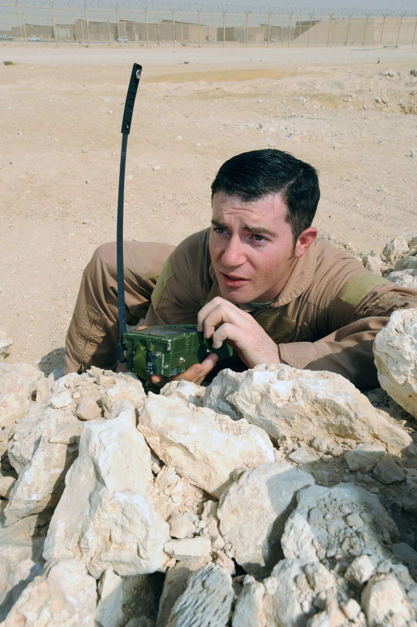 Staff Sgt. Eric Zwoll demonstrates the use of a PRC-112 survival radio March 17 at an air base in Southwest Asia. The radio is used to contact recovery forces if a member of an aircrew should become isolated in enemy territory. Sergeant Zwoll is a a survival, evasion, resistance, and escape specialist with the Combined Air and Space Operations Center. He is a native of Orma, W. Va., and is deployed from Fairchild Air Force Base, Wash. (U.S. Air Force photo/Staff Sgt. Joshua Garcia) 
