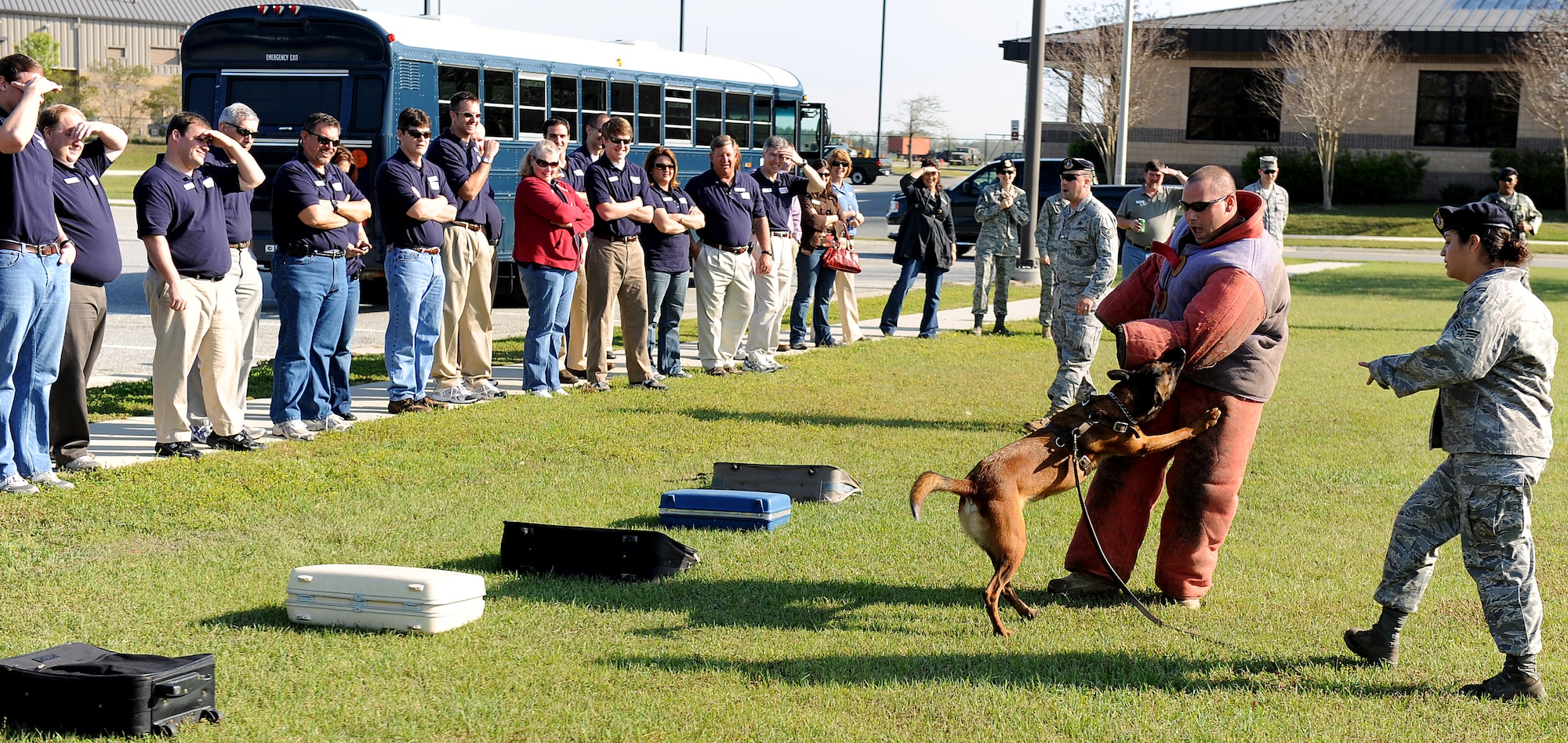MOODY AIR FORCE BASE, Ga. -- Staff Sgt. David Smith and Senior Airman Maria Melesio, both 23rd Security Forces Squadron military working dog handlers, along with Paco, a military working dog, demonstrate different scenarios for members of the Leadership Lowndes class here March 19. (U.S. Air Force photo by Airman Joshua Green) 