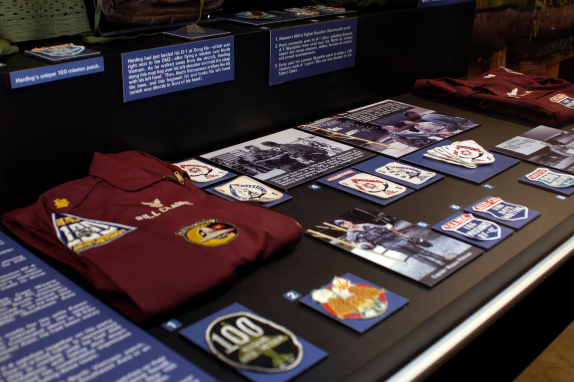 DAYTON, Ohio - On display: 42nd Tactical Electronic Warfare Squadron (TEWS) patch worn by Staff Sgt. Underwood. F-4 aircrews had several styles of 100 mission patches. Maj. William Clarke, an RF-4C pilot in the 14th Tactical Reconnaissance Squadron at Udorn, Thailand, donated this patch and party suit showing two different kinds. His party suit also has a Night Owl patch for flying at least 25 night reconnaissance missions and a Railroad Runners patch for flying along the railroad line from Hanoi to the Chinese border.F-4 and RF-4C aircrews also had their own playing card style patch for 100 missions and for 200 missions. Lt. Joel “Tom” Coney’s 100 mission RF-4 playing card patch (with North Vietnam tab). Coney, an RF-4C weapon system’s operator (WSO), also had a custom patch made to show his 228 mission total. From March 1968-March 1969, Capt. Wayne Pittman, 12th TRS, flew on 186 RF-4C combat missions over North Vietnam, South Vietnam, Laos, and Cambodia. He could not reveal his classified missions over Cambodia, so he had this patch made as SEA MISC (Southeast Asia Miscellaneous). Clark wore these F-4 patches together on his party suit like a poker four-of-a-kind hand. It represented his objective to stay in combat until he had 400 missions. Tour limitations and being shot down once, however, limited his nonetheless impressive total to 269 missions during three tours. Modeled after the F-105 North Vietnam patch, this shows 200 missions in Southeast Asia in an F-4 Phantom. F-100F Misty FACs spent much of their time over North Vietnam looking for targets, so they made patches that noted the number of hours flown over the North, like these donated by Misty FAC P.K. Robinson. Many aircrews put their 100 mission patches on their “party suits,” like this one from Capt. Patrick Savelli. An electronic warfare officer (EWO), he flew 100 missions in EB-66s and 100 missions in B-52Ds. (U.S. Air Force photo)