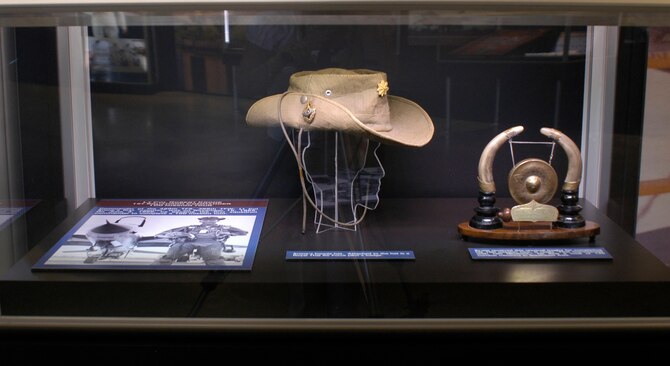 DAYTON, Ohio - Lt. Col. Robert Krone's boonie hat. Attached to the hat is a Royal Thai Air Force pilot’s badge. Also displayed is his unusual trophy for completing a 100-mission tour. It reads “First Commander with 100 Missions.” He flew a total of 125 combat missions in Southeast Asia. (U.S. Air Force photo)