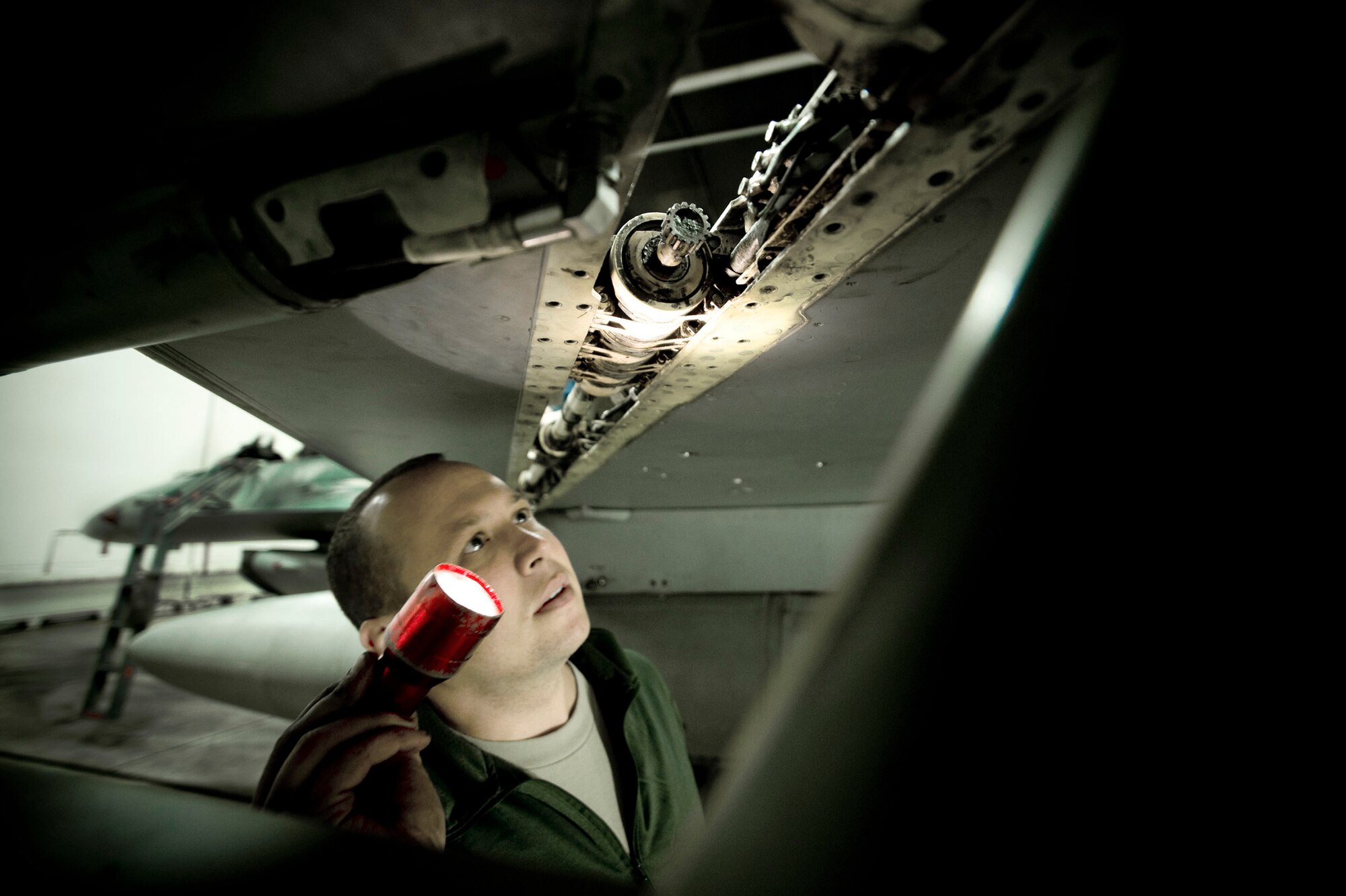 Technical Sgt. Nathan Bechdolt inspects the leading edge flap of an F-16 Fighting Falcon March 6 at Misawa Air Base, Japan. Sergeant Bechdolt, an F-16 crew chief is one of 31 Airmen deployed from the Air National Guard's 122nd Fighter Wing from Fort Wayne, Ind., to help the 35th Aircraft Maintenance Squadron during a low-manning period. (U.S. Air Force photo/Staff Sgt. Samuel Morse) 
