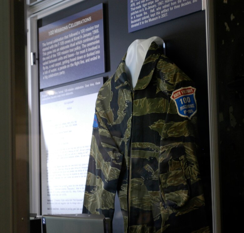 DAYTON, Ohio - This artifact has a remarkable story. In the summer of 1966, Air Force Academy Cadet Richard Hall visited McConnell AFB, and met Bruce Holmes. Holmes gave Cadet Hall this Thai-made tiger-stripe suit with one of his 100 mission patches on it. In January, 1967, Holmes was tragically killed in a house fire. Hall, who retired from the USAF as a lieutenant colonel, kept this artifact for three decades, and donated it to the museum in 2007. The artifact is on display in the 100 Missions Up North exhibit in the Southeast Asia War Gallery at the National Museum of the U.S. Air Force. (U.S. Air Force photo)