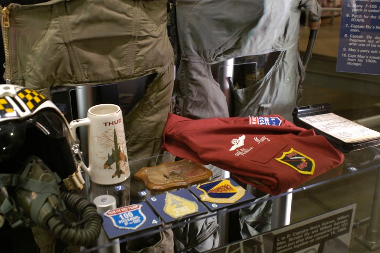 DAYTON, Ohio - Close-up of objects in the 100 mission celebrations display case in the 100 Missions Up North exhibit in the Southeast Asia War Gallery at the National Museum of the U.S. Air Force. (U.S. Air Force photo)