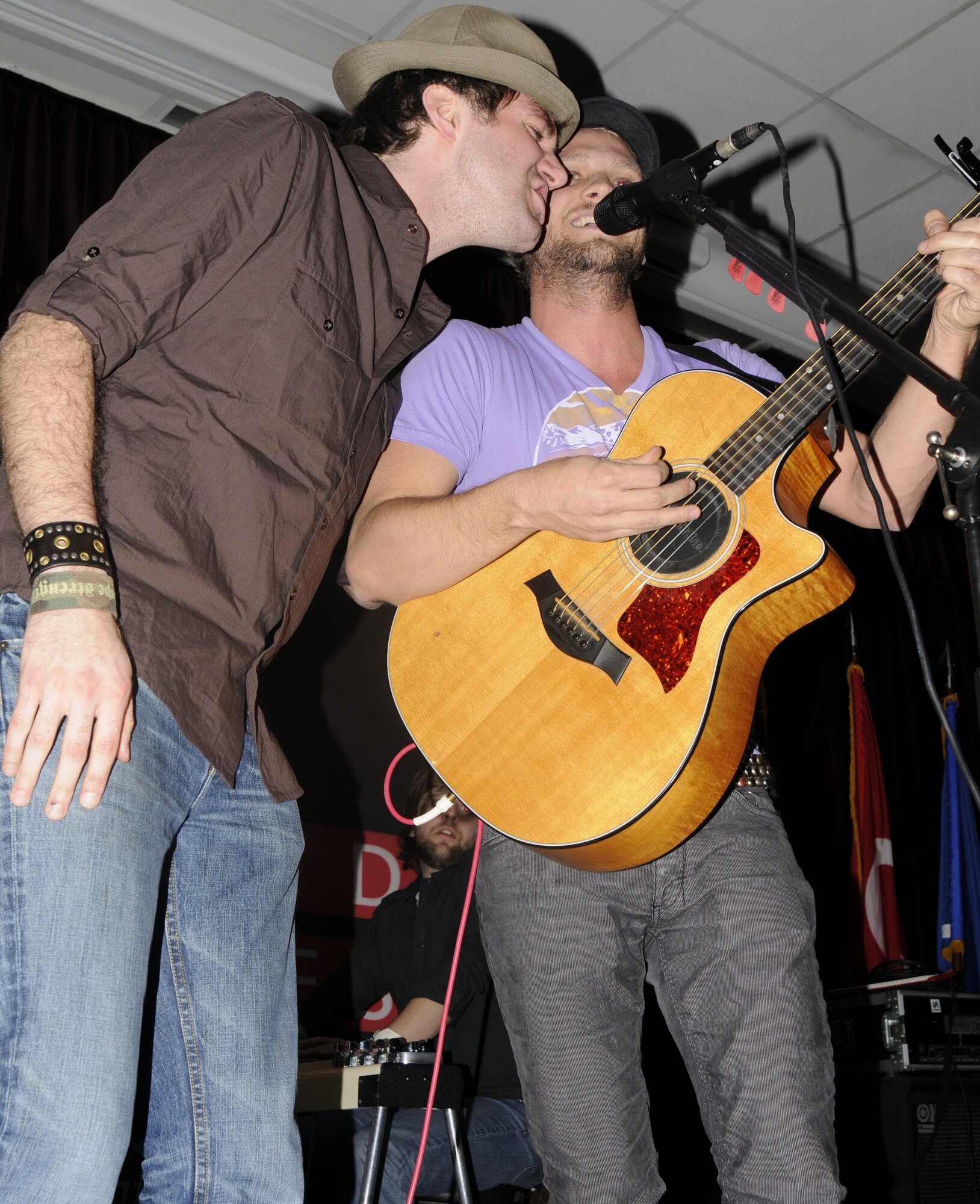 Stephen Kellogg, from the Stephen Kellogg and the Sixers band, joins Andrew Ripp for a few chords during a performance at Incirlik’s Consolidated Club.  Andrew Ripp and his band opened for “Stephen Kellogg and the Sixers” during an Armed Forces Entertainment tour of military bases in several countries. (U.S. Air Force photo/Airman 1st Class Amber Russell)
