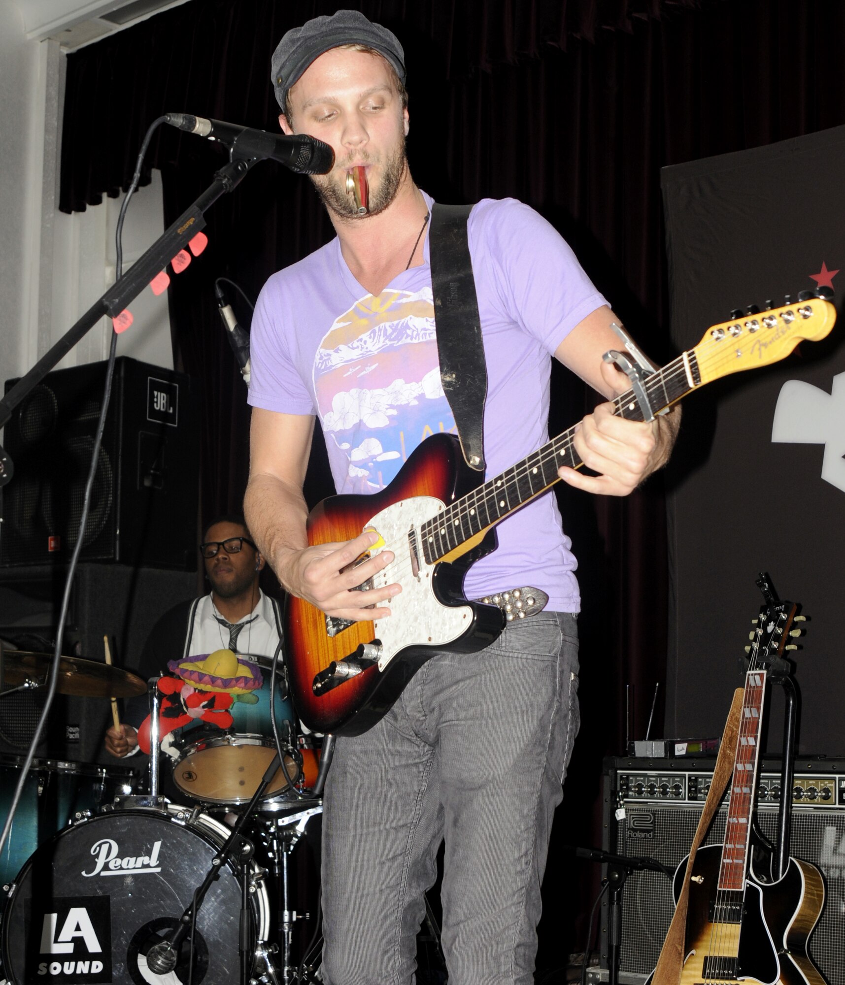 Andrew Ripp, guitarist and lead singer for the self-titled Andrew Ripp band, adds a kazoo into a song during an opening act for the band, “Stephen Kellogg and the Sixers,” March 20 at Incirlik’s Consolidated Club. Both bands are traveling with Armed Forces Entertainment to different military bases to boost morale in several different countries. (U.S. Air Force photo/Airman 1st Class Amber Russell)