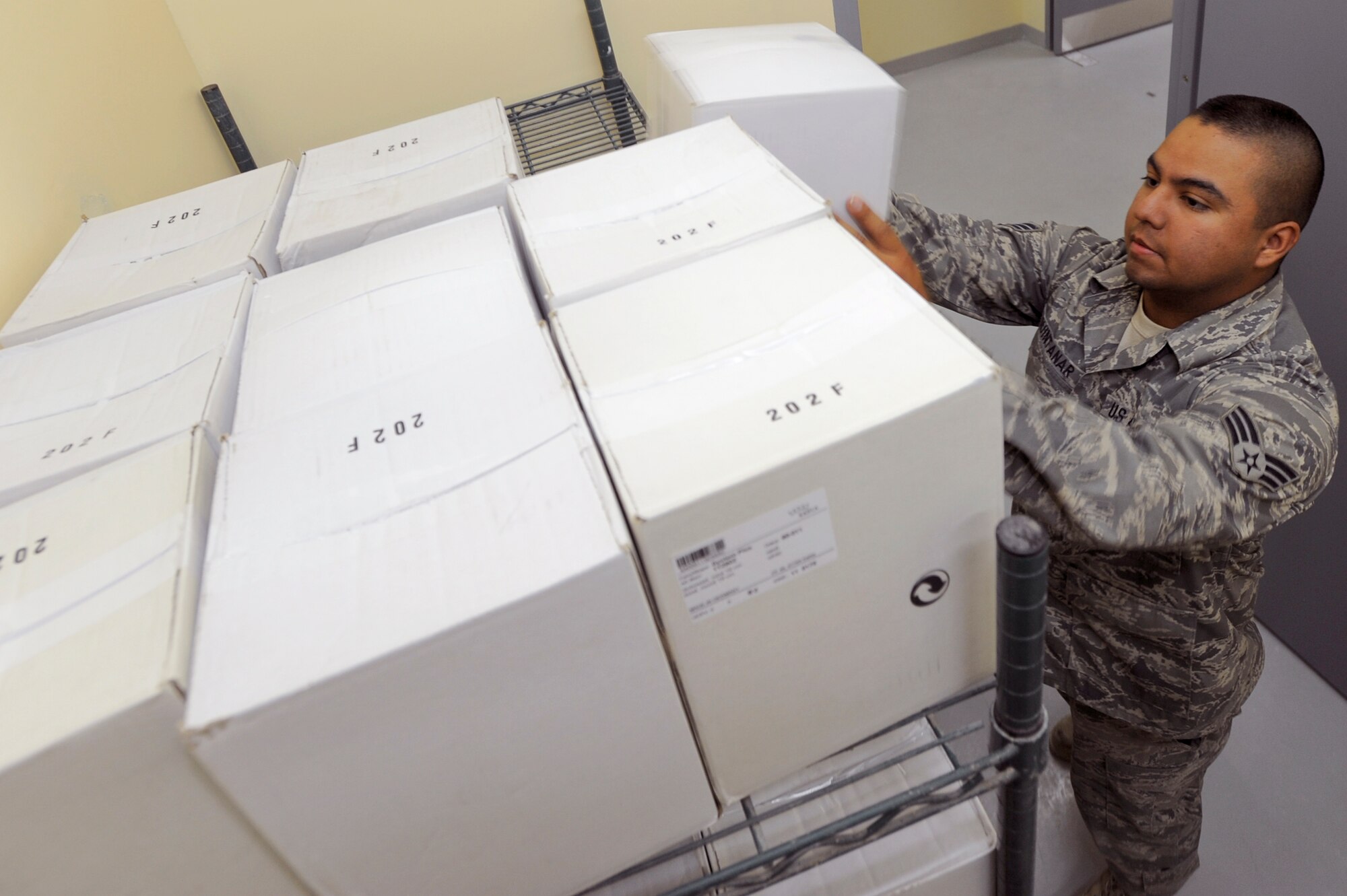 Senior Airman Ricardo Quintanar, a services journeyman with the 379th Expeditionary Force Support Squadron, stocks the new Coalition Compound dining facility with supplies, March 23, 2009, in an undisclosed location in Southwest Asia.  The new dining facility is scheduled to open shortly and Airman Quintanar is doing his part to ensure it will be fully stocked and operational for opening day.  Airman Quintanar is native to Austin, Texas and is deployed from Dyess Air Force Base, Texas in support of Operations Iraqi and Enduring Freedom and Combined Joint Task Force - Horn of Africa. (U.S. Air Force Photo by Staff Sgt. Joshua Garcia/released)