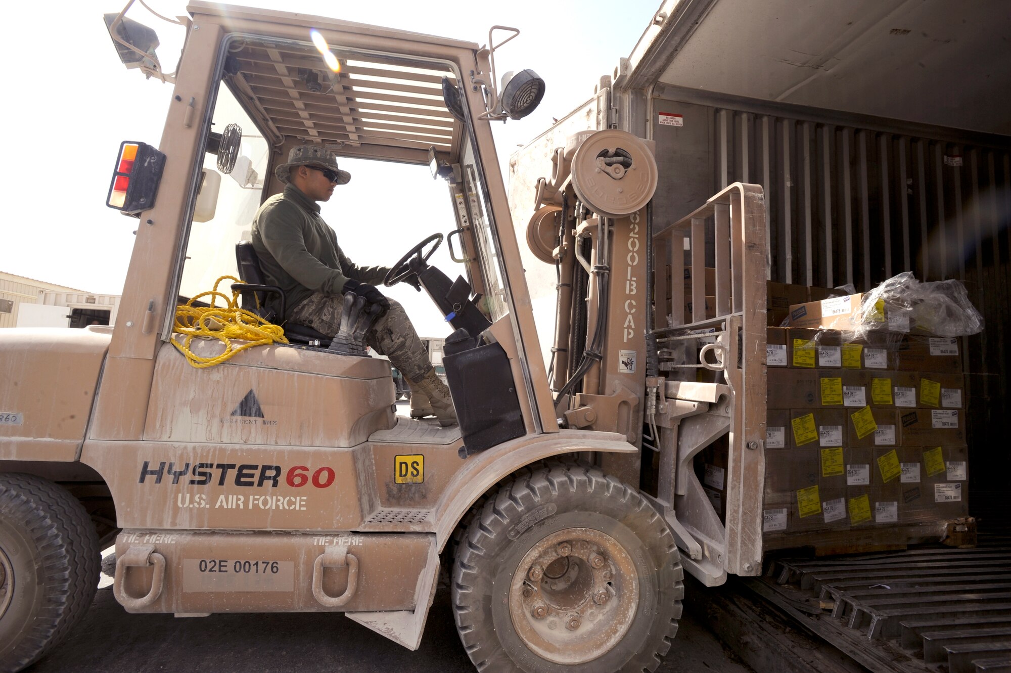 Staff Sgt. Samneng Seng, restocks a food storage container with supplies, March 23, 2009, in an undisclosed location in Southwest Asia.  Sergeant Seng is with the 379th Expeditionary Force Support Squadron and is the store room manager for the Independence Dining Facility where he ensures all the food on the menu for the following day is ordered and stocked properly.  Sergeant Seng is native to Lynn, Mass. and is deployed from Pease Air National Guard Base, N.H. in support of Operations Iraqi and Enduring Freedom and Combined Joint Task Force - Horn of Africa. (U.S. Air Force Photo by Staff Sgt. Joshua Garcia/released)