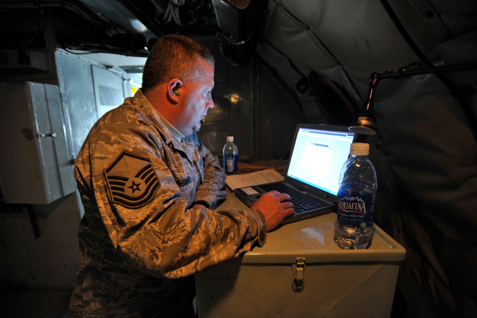 Master Sgt. Paul McGinnis uses the galley of an inflight KC-135 Stratotanker as a desk to work on some computer-based training during an aeromedical evacuation mission in March. A training frenzy aimed at freeing up future drilll weekends for members of the 931st Air Refueling Group's is scheduled for mid-April. Sergeant McGinnis is assigned to the 931st Aircraft Maintenance Squadron, an Air Force Reserve unit at McConnell Air Force Base, Kan. (U.S. Air Force photo)