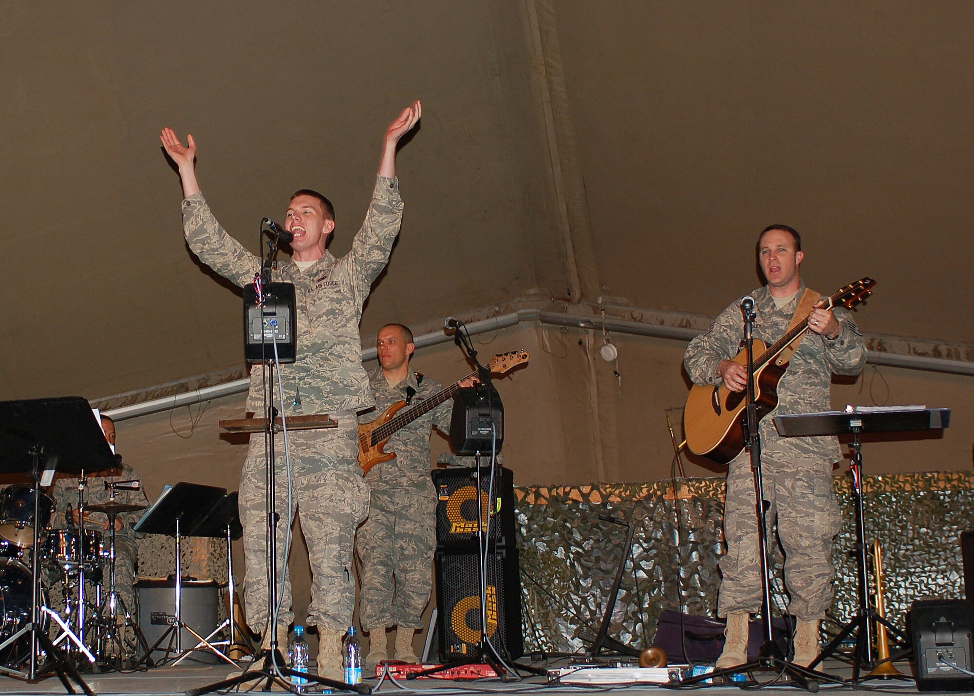 Senior Airman Christopher Girardeau shows off his singing talents as a guest vocalist with Sirocco during the U.S. Air Forces Central Expeditionary Band's last performance March 21 at Manas Air Base, Kyrgyzstan. The band members are deployed to Southwest Asia from the U.S. Air Forces in Europe Band at Sembach AB, Germany. Airman Girardeau is assigned to the 376th Expeditionary Logistics Readiness Squadron and is deployed from Charleston Air Force Base, S.C. (U.S. Air Force photo/Tech. Sgt. Elizabeth Weinberg)