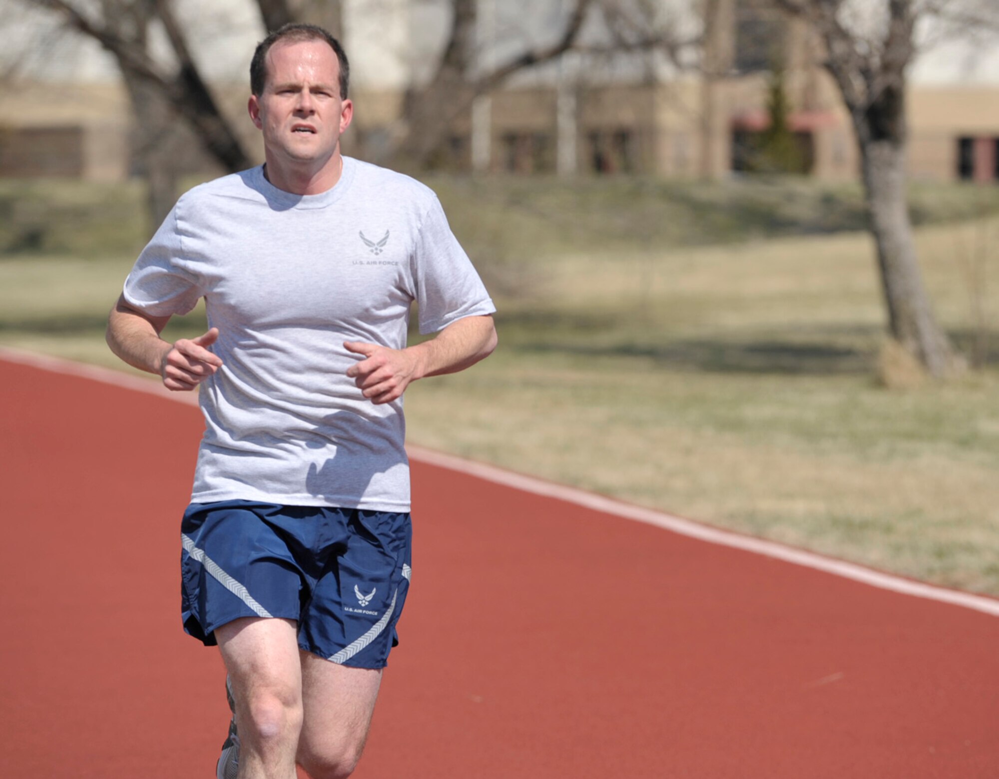 Capt. Layne Wroblewski nears the finish line of an outdoor track at McConnell Air Force Base, Kan., during the 931st Air Refueling Group's drill weekend in March. Group-wide fitness testing is scheduled to coincide with a five-day "Training Frenzy" in April. Captain Wroblewski is assigned to the 931st Equal Opportunity office and is one of the 931st ARG's "excellent" fitness performers. (U.S. Air Force photo/Tech. Sgt. Jason Schaap)
