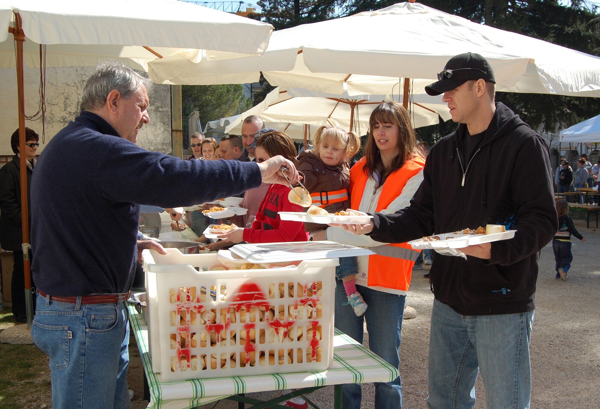Members of the Aviano community serve volunteers a hot meal March 22 as part of Aviano Ecological Day. More than 300 Airmen, civilians and family members from the base teamed up with volunteers within the Aviano community to rid the streets of trash. (U.S. Air Force photo/Staff Sgt. Lindsey Maurice)