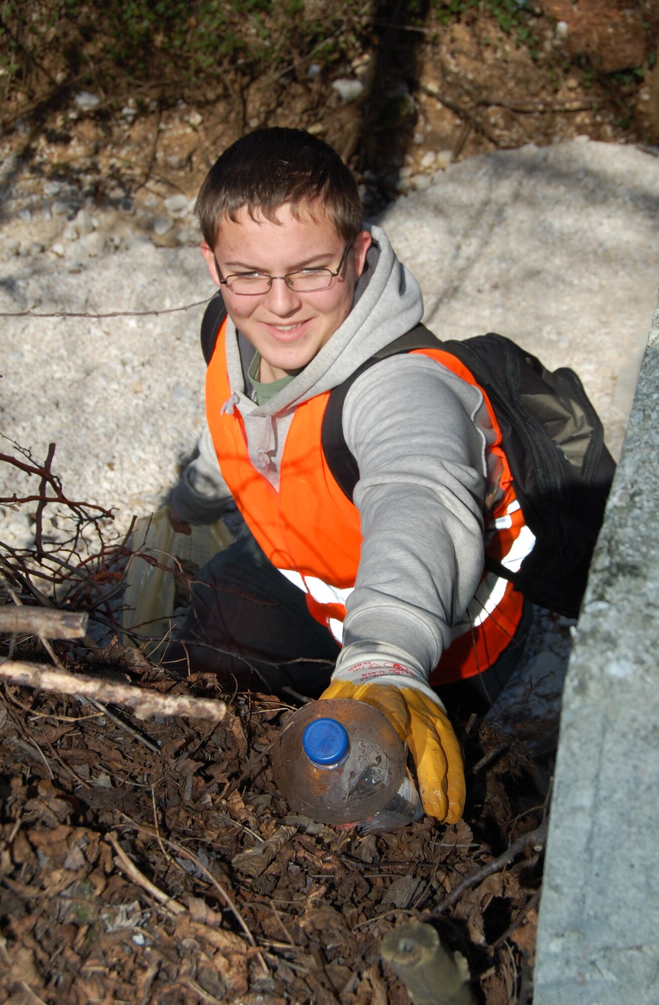 Cory Keena, son of Capt. Lisa and Patrick Keena, picks up a discarded plastic bottle during the Aviano Ecological Day March 22. More than 300 Airmen, civilians and familiy members teamed up with the local community to clean the streets of Aviano, Italy. (U.S. Air Force photo/Staff Sgt. Lindsey Maurice)