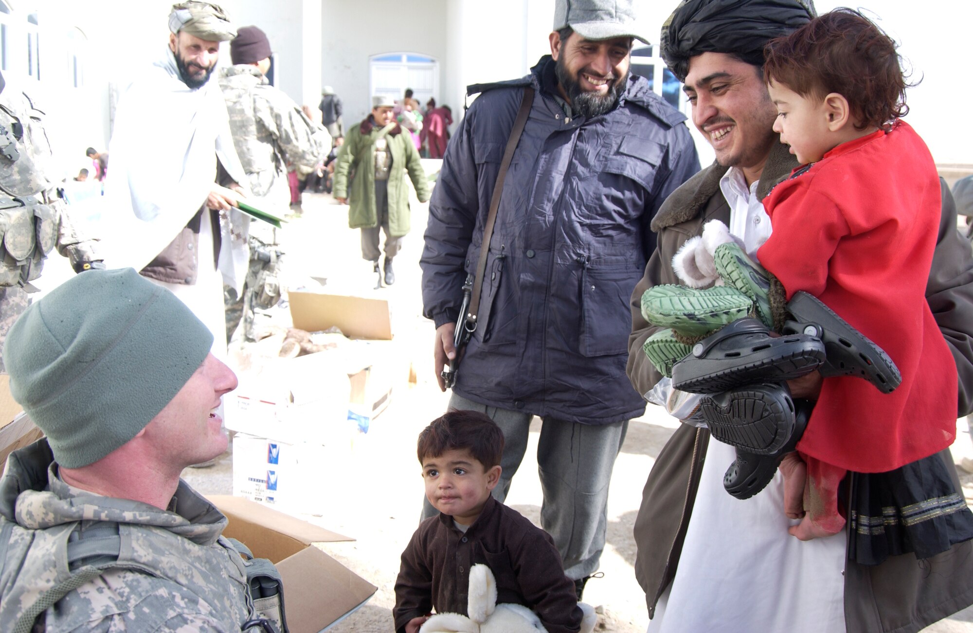 Nearly 200 children waited anxiously as Staff Sgt. Josh Paden and the members of the Zabul Provincial Reconstruction Team distributed the boxes filled with donations. Sergeant Paden, with the help of his mother, Diane Paden and the Pendleton County community in West Virginia, were able to give shoes, clothes and toys to the children of Qalat City, Afghanistan. (U.S. Air Force photo by 1st Lt. Amber Balken)