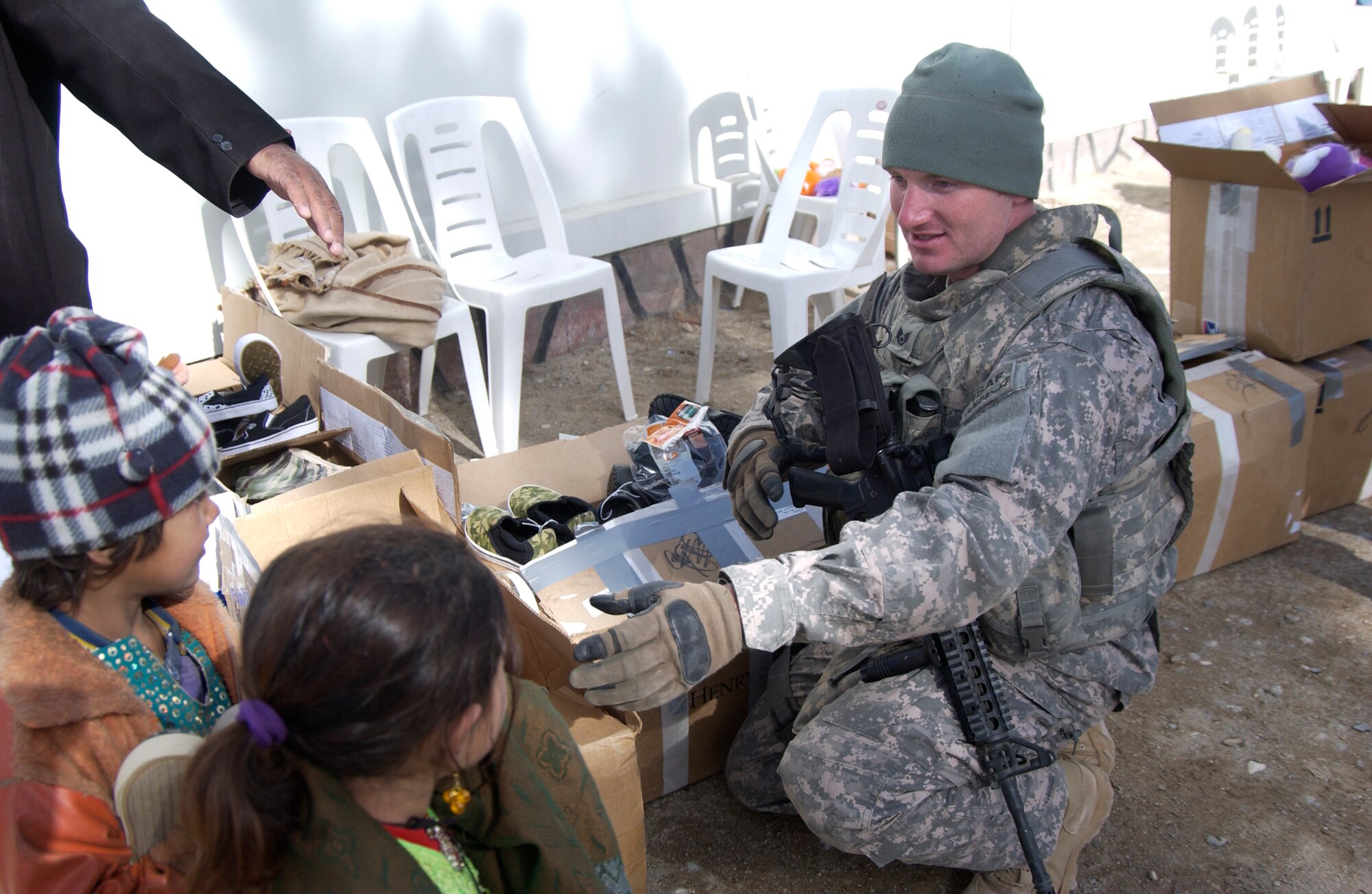 Nearly 200 children waited anxiously as Staff Sgt. Josh Paden and the members of the Zabul Provincial Reconstruction Team distributed the boxes filled with donations. Sergeant Paden, with the help of his mother, Diane Paden and the Pendleton County community in West Virginia, were able to give shoes, clothes and toys to the children of Qalat City, Afghanistan. (U.S. Air Force photo by 1st Lt. Amber Balken)