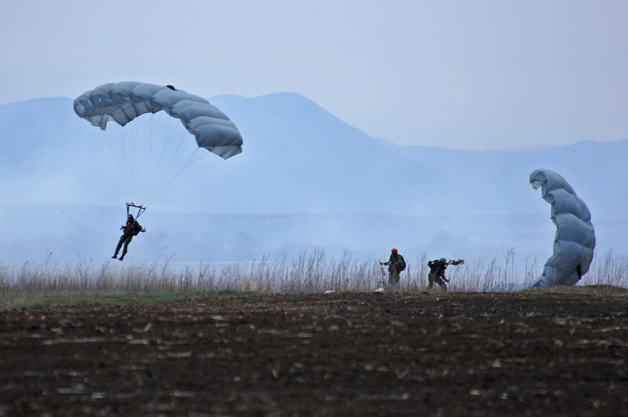Bulgarian paratroopers with the 68th Bulgarian Special Forces Brigade, parachute down over the drop-zone after performing a High Altitude, Low Opening jump alongside U.S. paratroopers during Operation Thracian Spring, Bezmer Air Base, Bulgaria, March 11, 2009. This exercise was first conducted in 2007, and is the third annual cooperative endeavor of the 86th Contingency Readiness Squadron, the 37th Airlift Squadron and the Bulgarian Armed Forces. (U.S. Air Force photo by Airman 1st Class Tony R. Ritter)
