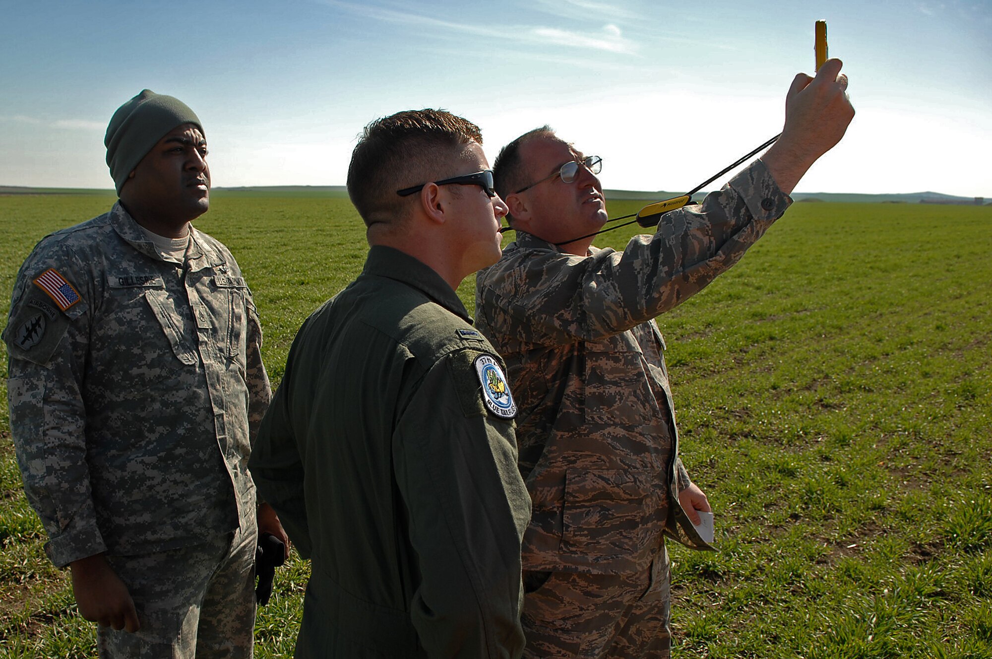 U.S. Army Staff Sgt. Ronnell Gillespie (left), 5th Quartermaster Company air drop platoon sergeant, U.S. Air Force Tim Fast, 37th Airlift Squadron C-130 co-pilot, and U.S. Air Force Maj. Michael Sheldon, 86th Operation Support Squadron lead exercise planner, perform a wind reading at the drop zone in preparation for a paratrooper static-line jump during Operation Thracian Spring , Bezmer Air Base, Bulgaria, March 9, 2009. Conducted annually since 2007, Operation Thracian Spring is a two week exercise allowing U.S. forces an opportunity to train and interact with their Bulgarian counterparts. (U.S. Air Force photo by Airman 1st Class Tony R. Ritter)