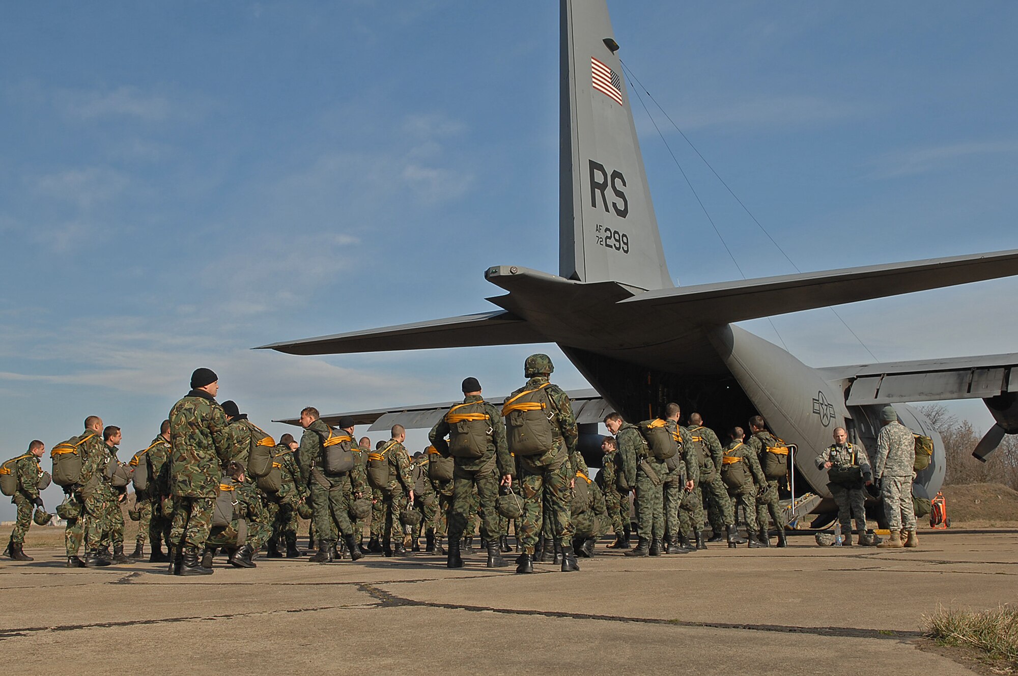 Bulgarian paratroopers and U.S paratroopers with the Air Forces' 786th Security Forces Squadron and the Army's 5th Quartermaster Company prepares to board a C-130E Hercules. The paratroopers are preparing to conduct a joint training static line jump during Operation Thracian Spring, Bezmer Air Base, Bulgaria, March 9, 2009. Conducted annually since 2007, Operation Thracian Spring is a two week exercise allowing U.S. forces an opportunity to train and interact with their Bulgarian counterparts. (U.S. Air Force photo by Airman 1st Class Tony R. Ritter)