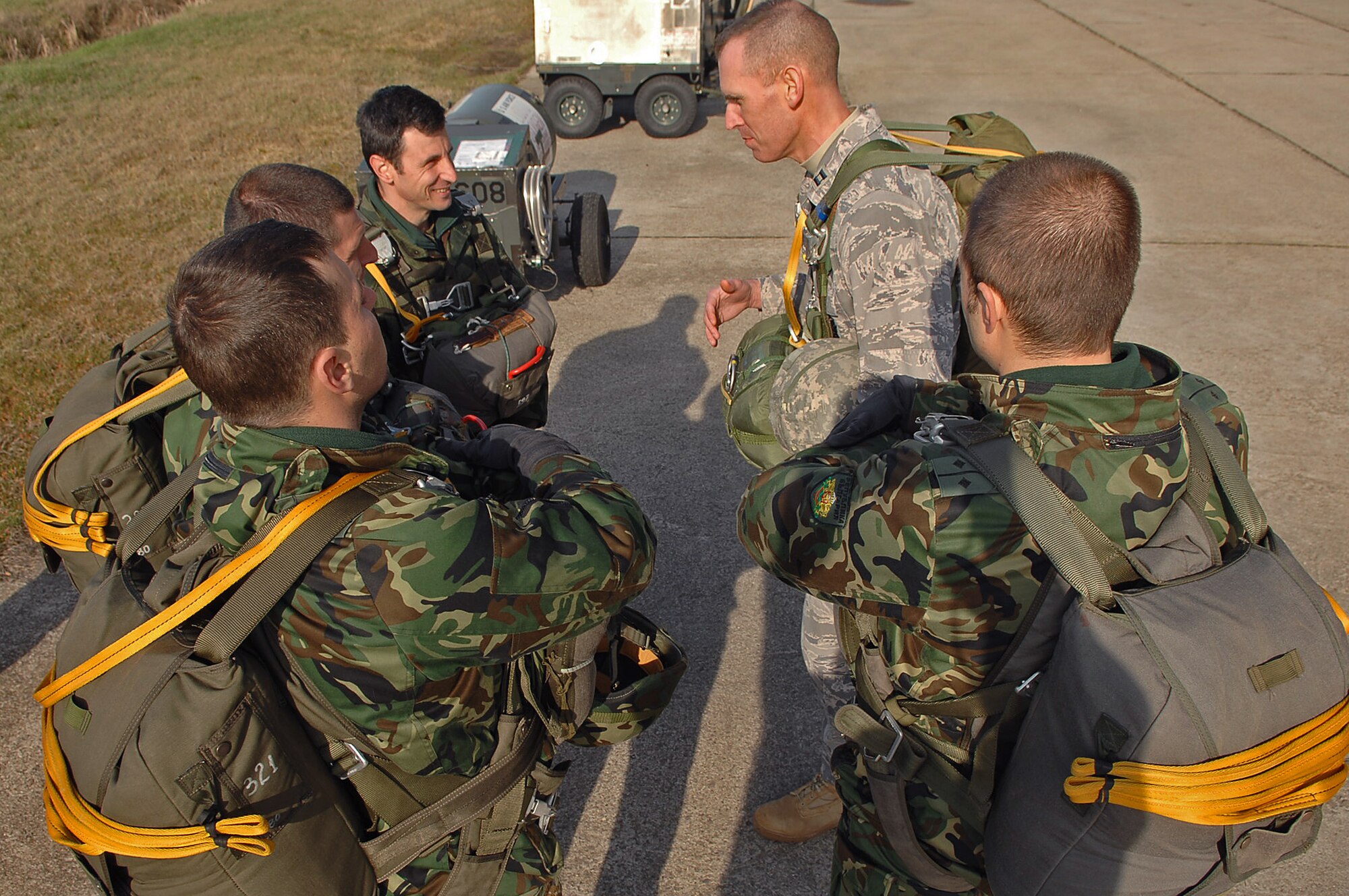 Bulgarian Lt. Col Petko Petkov, Paratrooper, 68th Bulgarian Special Forces Brigade chief of training, and other paratroopers with the 68th, conduct a brief with U.S. Air Force Capt. Mark Breed, 786th Security Forces Squadron operations officer, moments before participating in a static-line jump during Operation Thracian Spring, Bezmer Air Base, Bulgaria, March 9, 2009. Conducted annually since 2007, Operation Thracian Spring is a two week exercise allowing U.S. forces an opportunity to train and interact with their Bulgarian counterparts. (U.S. Air Force photo by Airman 1st Class Tony R. Ritter)