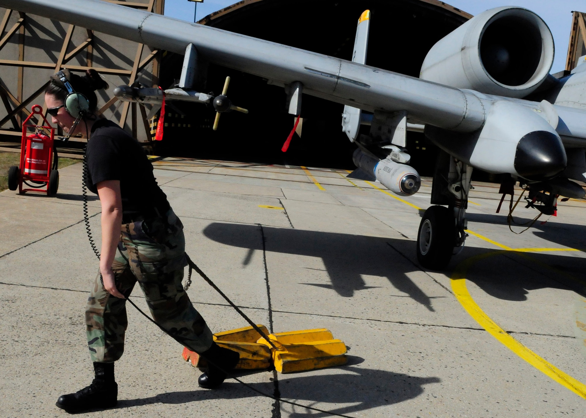 SPANGDAHLEM AIR BASE, Germany – Staff Sgt. Katherine Andrews, 52nd Aircraft Maintenance Squadron, pulls chalks from an A-10 Thunderbolt II, during a pre-flight inspection March 18, 2009. The inspection ensures that there are no problems with the aircraft before take-off. (U.S. Air Force photo by Airman 1st class Nicholas Wilson)