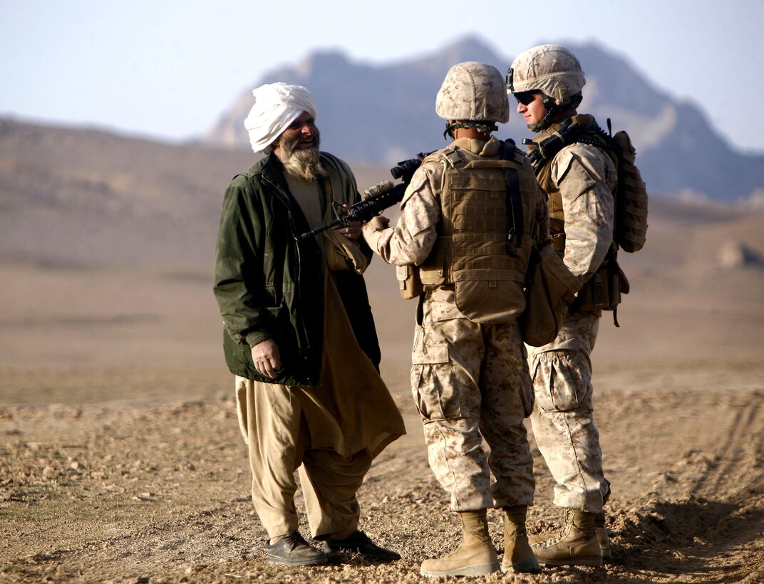 U.S. Marine 2nd Lt. Daniel M. Yurkovich (right) and Lance Cpl. Farid Hotaki speak with an Afghan man as he makes his way home in Golestan, Farah province, Islamic Republic of Afghanistan, March 13, 2009. Yurkovich is the second platoon commander for Company K, 3rd Battalion, 8th Marine Regiment (Reinforced), the ground combat element of Special Purpose Marine Air Ground Task Force – Afghanistan. Yurkovich and his Marines spend a great deal of time engaging the local populace to gain intelligence on insurgent activity in the area and to inquire about the peoples’ needs and concerns.SPMAGTF-A’s mission is to conduct counterinsurgency operations, with a focus on training and mentoring the Afghan national police.