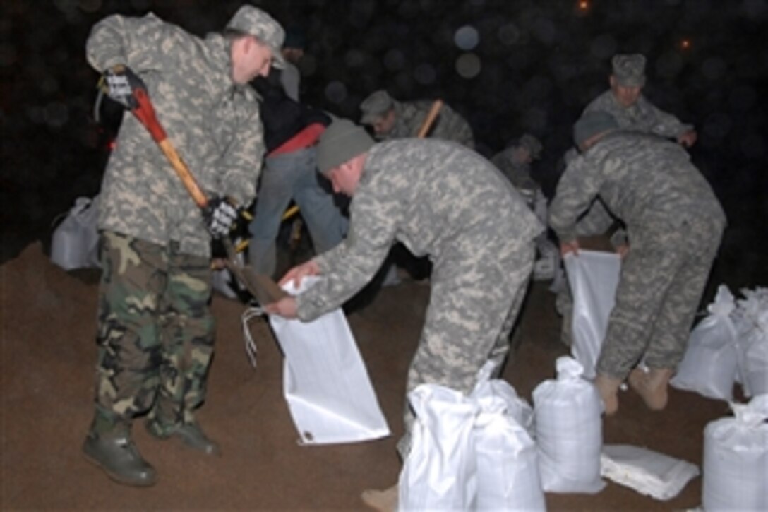 North Dakota National Guard troops fill sandbags in response to recent flooding in their state. As of March 23, 2009, more than 250 soldiers and airmen from the state have been called out to help stem the flow of floodwaters from the Red River in the Fargo area. 