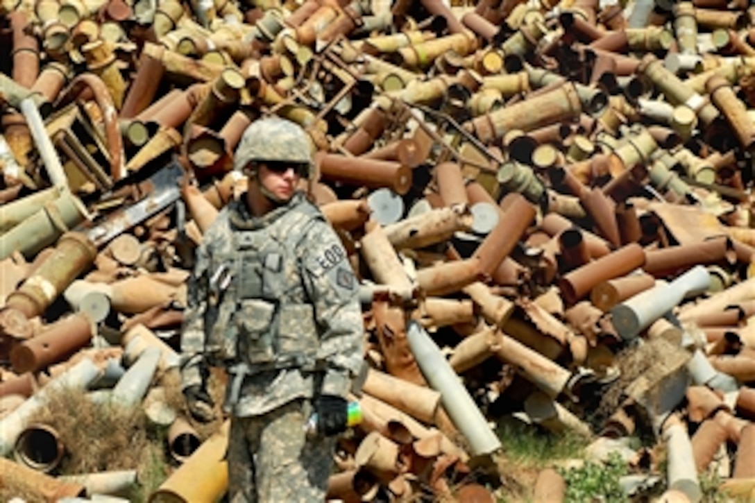 U.S. Army Sgt. Robert Solesbee looks around for potentially dangerous ordnance at Sheik Khalid scrap yard on Camp Taji, Iraq, March 18, 2009. Solesbee is assigned to the 710th Explosive Ordnance Disposal Company, 3rd Ordnance Battalion, 71st Ordnance Group.