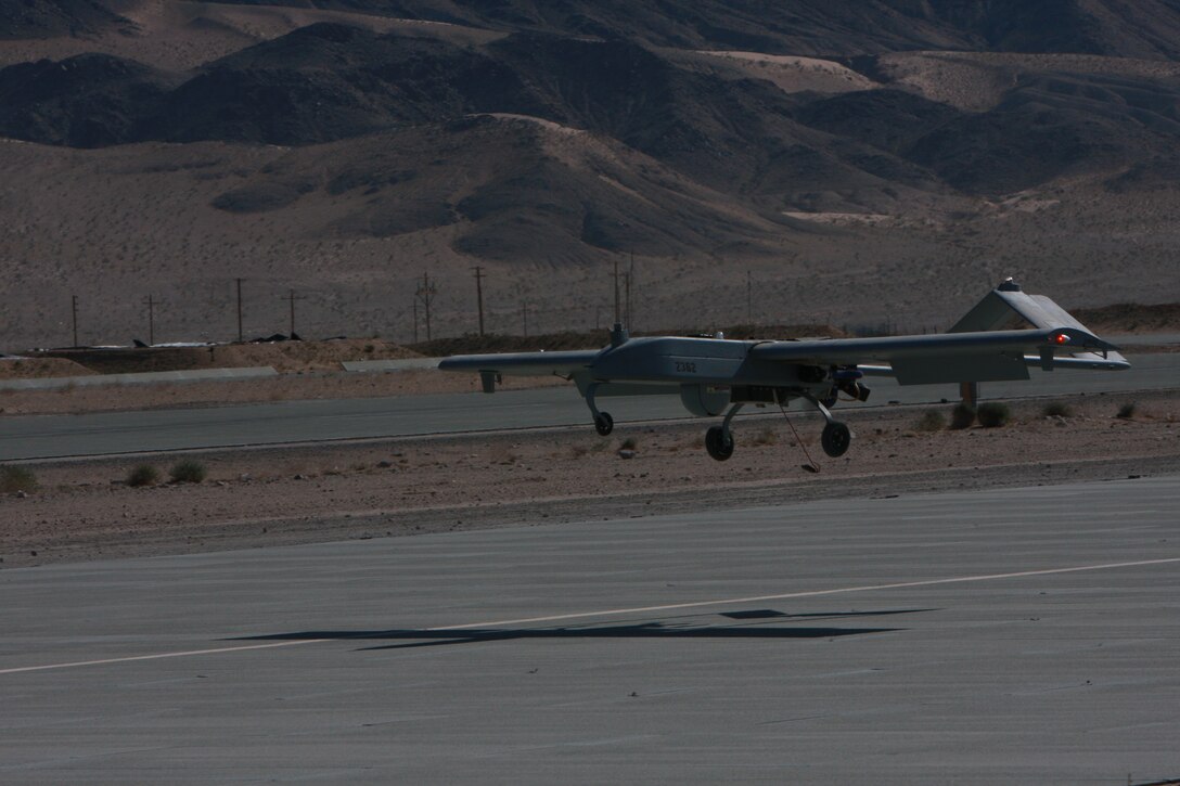 The RQ-7B, also known as the Shadow 200, lands at the Combat Center’s Expeditionary Air Field as Staff Sgt. Jacksby Sewell and Sgt. James Marquardsen prepare to end their qualification flight.